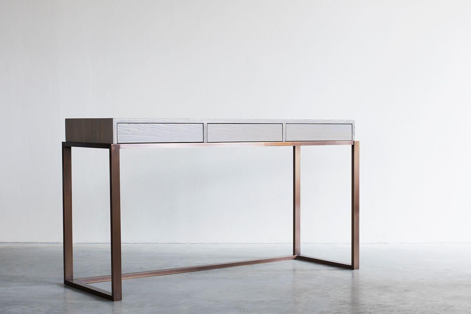 Nota Bene console table by Van Rossum
Dimensions: D150 x W50 x H75 cm
Materials: Oak, brass.

The wood is available in all standard Van Rossum colors, or in a matching finish to customer’s own sample.
Detailing is available in stainless steel