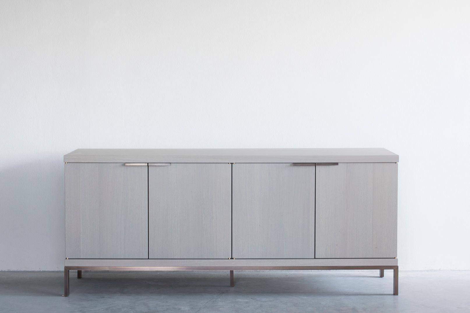 Nota Bene sideboard by Van Rossum
Dimensions: D181 x W49 x H75 cm
Materials: Oak, brass.

The wood is available in all standard Van Rossum colors, or in a matching finish to customer’s own sample.
Detailing is available in stainless steel or
