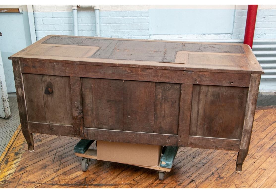 A secretaire a deux corps with a tall separately made upper cabinet. The top with three curved drawers over double doors with French leather bound book spines, 18th century. Opening to a chinoiserie wall papered interior with one shelf (worn). The