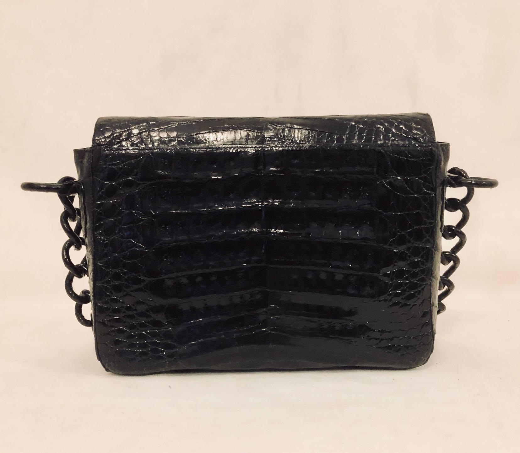 Nancy Gonzalez black crocodile shoulder bag with unique covered chain strap with 14.50 drop is spectacular for day or night.   This bag exhibits a flap top with hidden magnetic snap for closure.  The interior has a triple gusset and is lined in