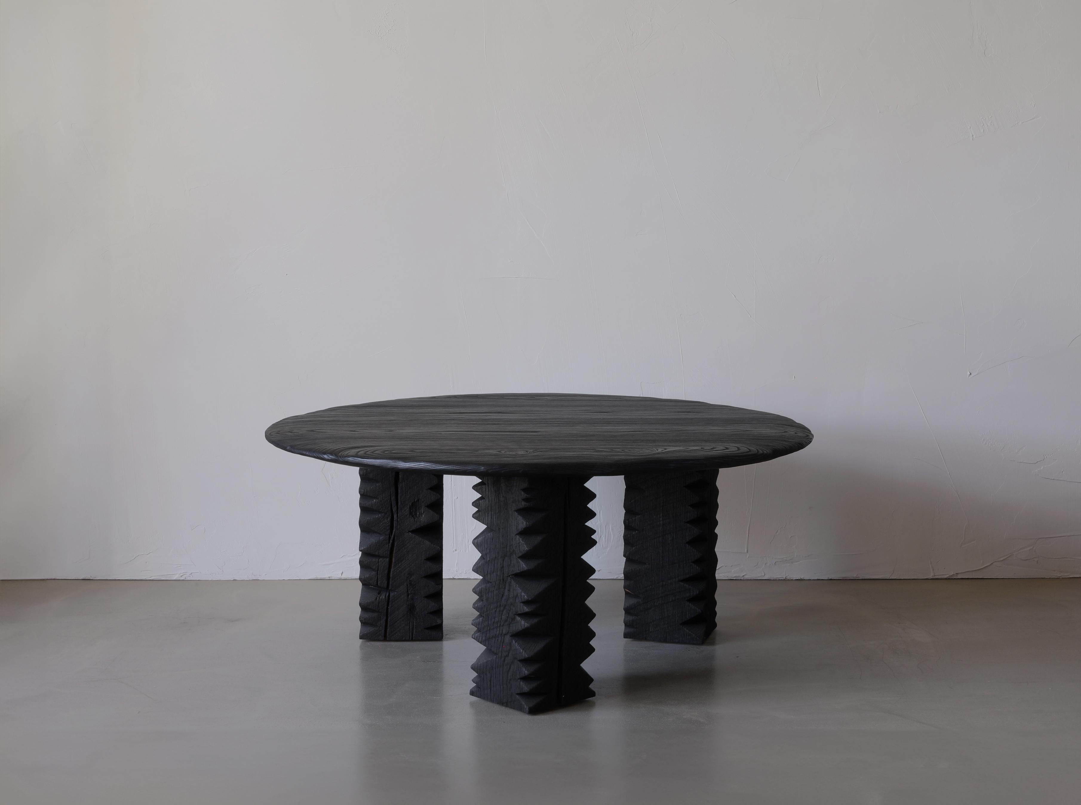 Notch III is a coffee table made up of three solid pedestal legs and a large charred and brushed top.

This collection finds its foundation in ‘cribbage’,  a rough-cut lumber used to build support structures called ‘cribs’ in coal mines. This