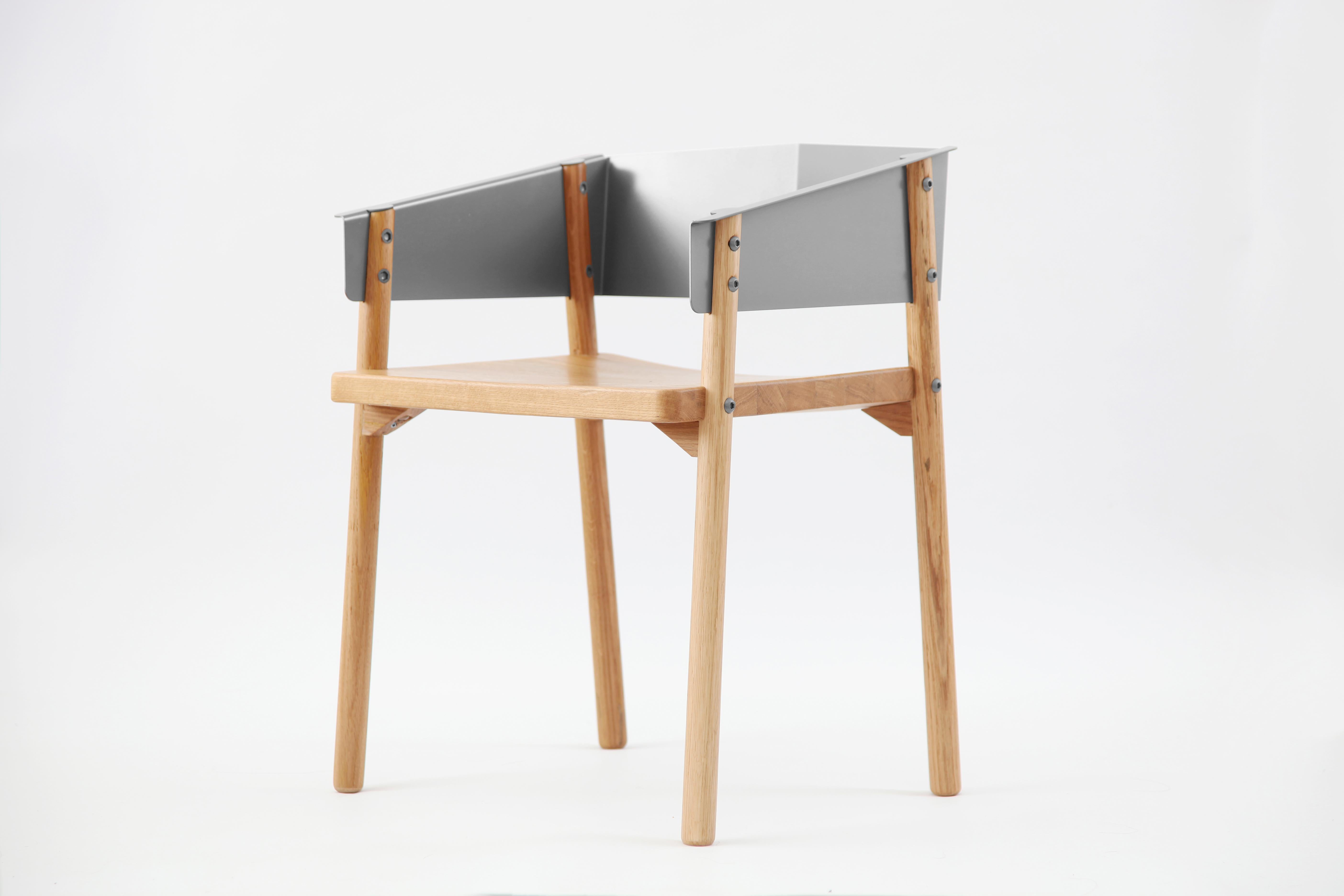 The aesthetics of Note Chair is to maximize and integrate forms with distinctive materials. The minimal white oak legs interlock with the folded-cutout-sheet-metal arms/seatback visually and structurally. The out-folded semicircles of the arm rests