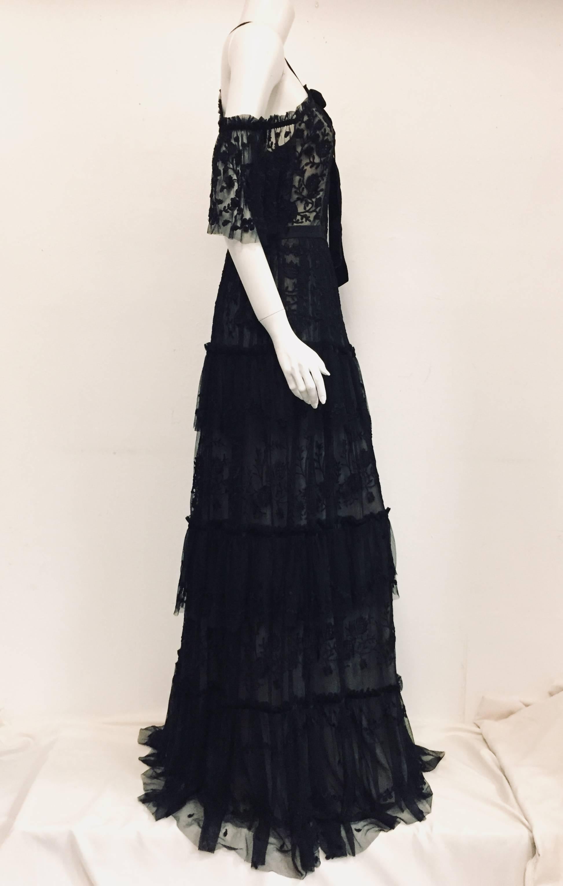 Needle & Thread's creative director Hannah Coffin works closely with skilled artisans to create her embellished designs. Inspired by the Andromeda Galaxy, this gown is cut from delicate embroided tulle.  The gown is decorated with a black velvet 