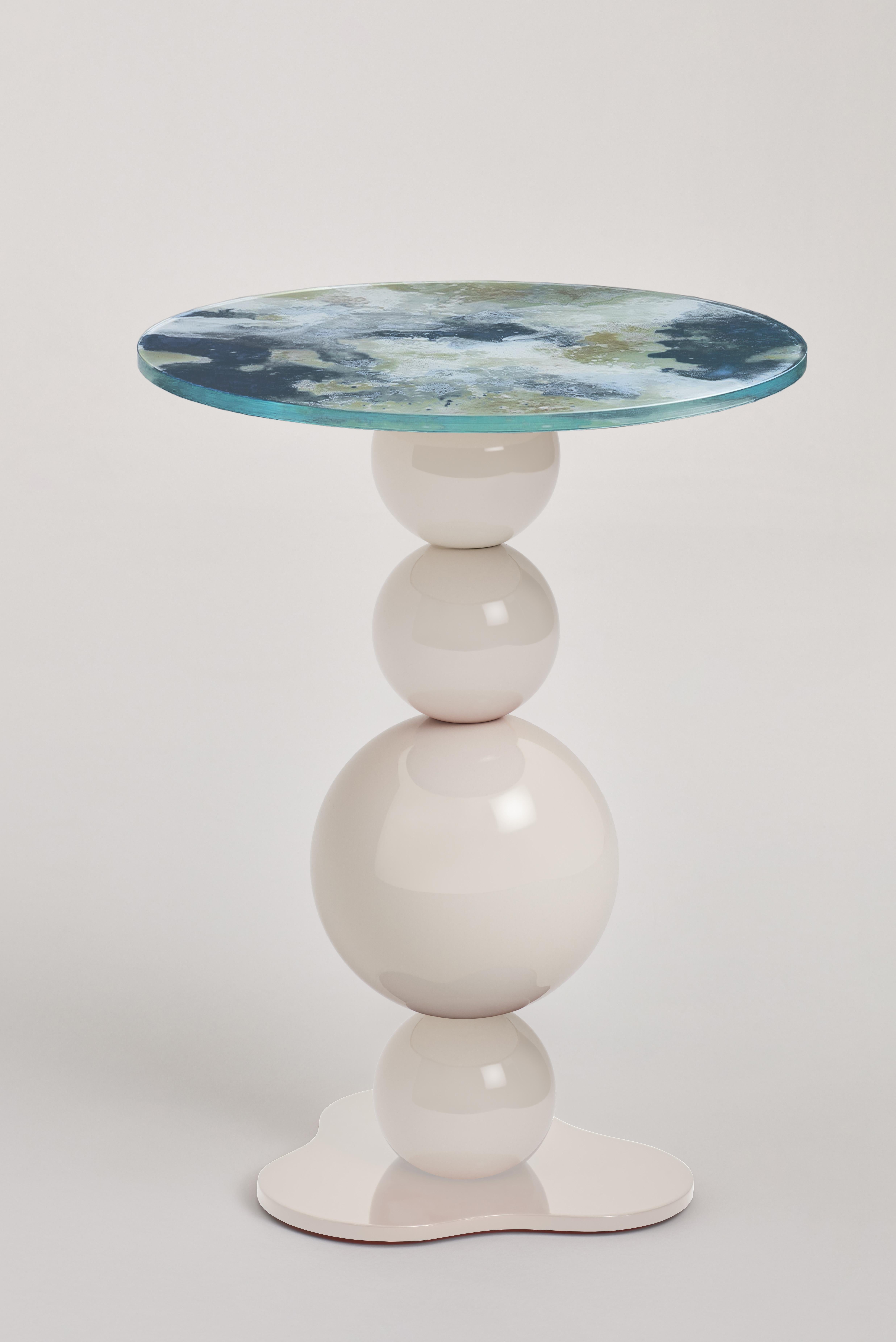 Noto Side Table by Le Berre Vevaud
Dimensions: W 42 x D 42 x H 55 cm.
Materials: Eglomized glass top Legs composed of 4 tulipwood balls in New Ivory RAL 9001 glossy lacquered brass. 


For over 15 years, Raphaël Le Berre and Thomas Vevaud have been