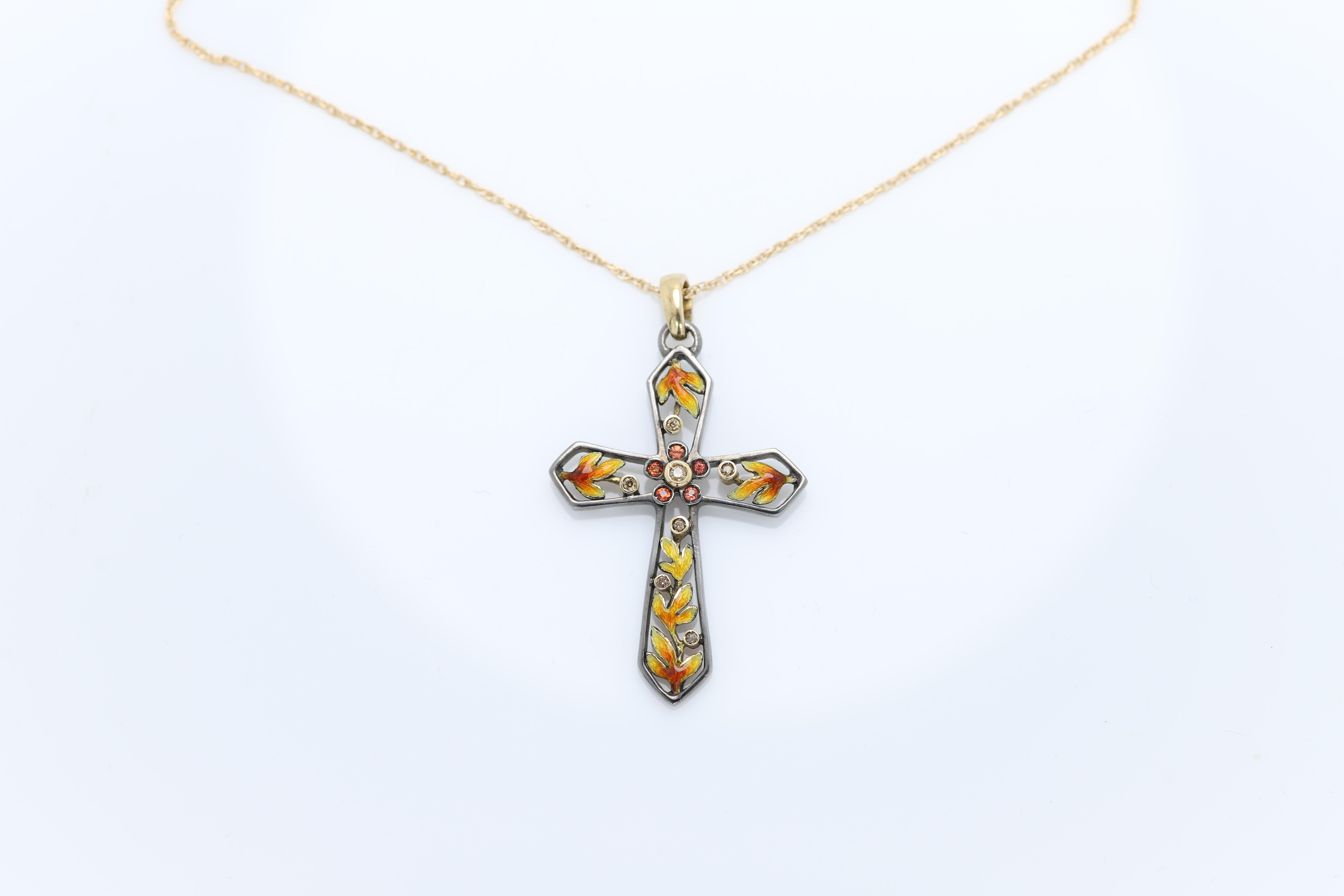 Fire Enamel Cross with diamonds and Orange Sapphire, 
Brilliant colors, elegant and unique.
18k yellow gold
oxidized sterling silver 925 
orange sapphire 
champagne diamonds
Hand made in Spain
Size: 1.5' Inch (length)
total weight 6.4 grams (silver