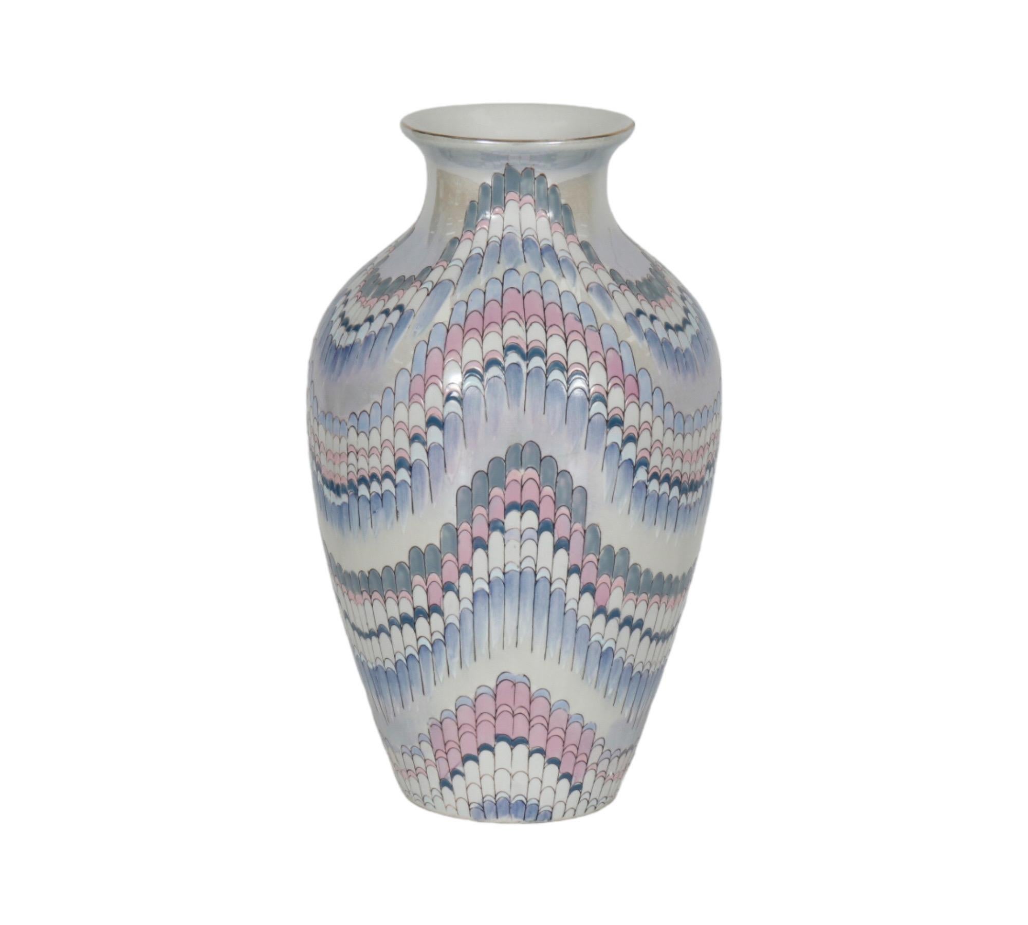 A Nouveau Lustre ceramic vase made by Toyo. Lightly embossed with a flame stitch pattern and hand painted with iridescent pink, purple, blue and jade hues over white. Marked underneath ‘Nouveau Lustre, Toyo, Made in China’.
