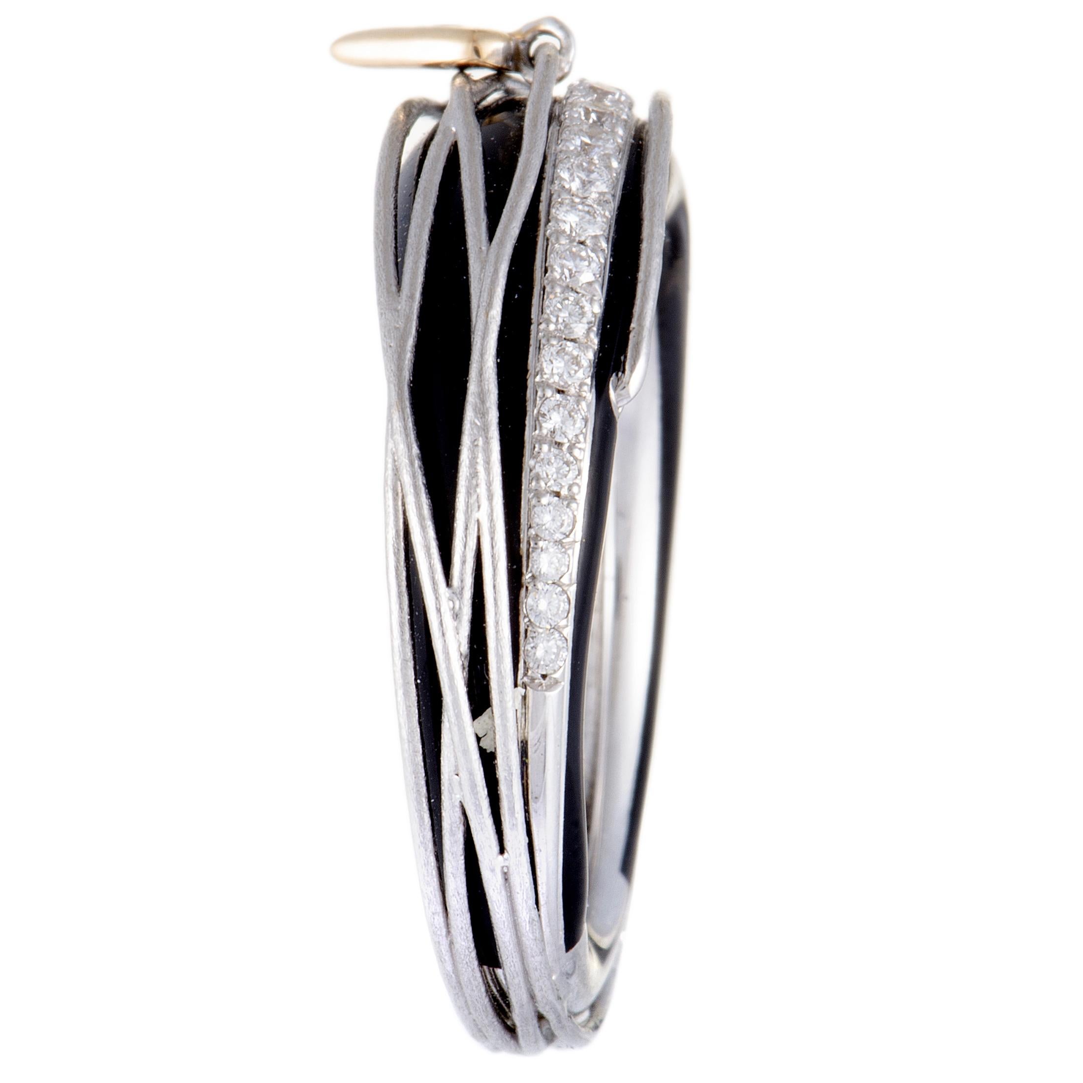 Contrasting one another in a most eye-catching manner, the gleaming white gold and the captivating black enamel create a stunningly fashionable effect in this gorgeous jewelry piece that is also embellished with sparkling white diamonds. The ring is