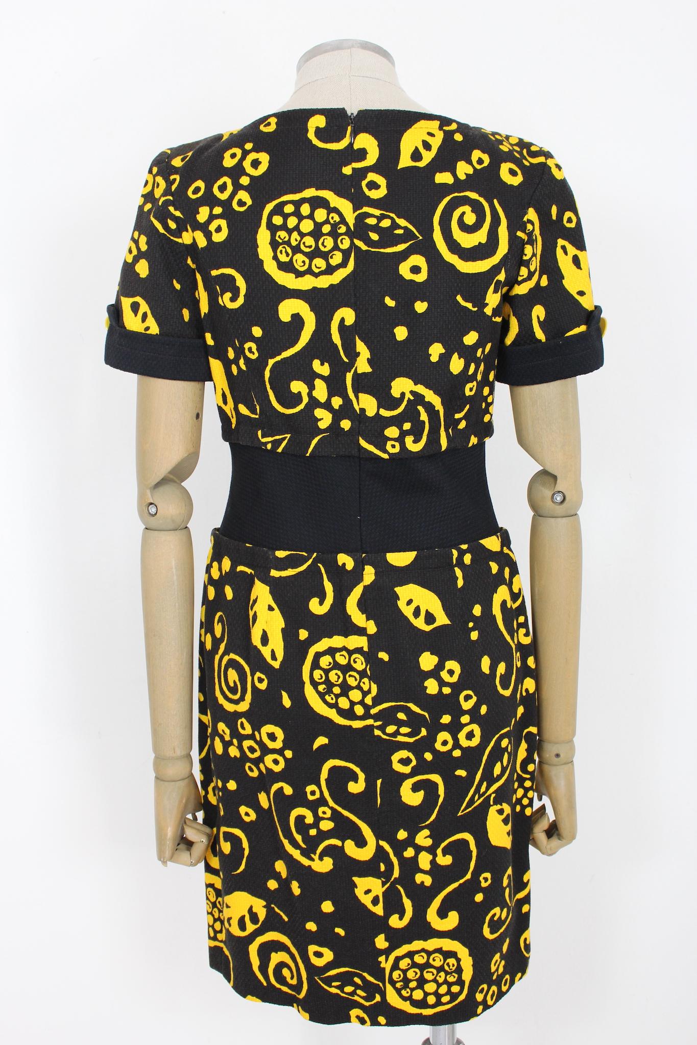 Nouvelle Couture Womenstyl vintage 70s cocktail dress. Black and yellow sheath dress with geometric designs. Short sleeve, applied yellow buttons with logo on the waist. Cotton fabric, zip closure along the back. Made in France.

Size: 42 It 8 Us 10