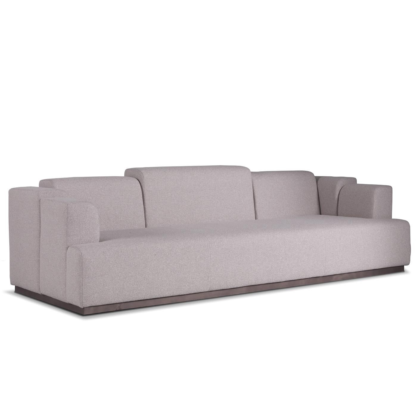 Inspired by the 1980s style, this striking sofa is a one-of-a-kind piece that will make a statement in any living room. Boasting an elegant grey color, it is marked by a unique back with sections of different measures that create a captivating and