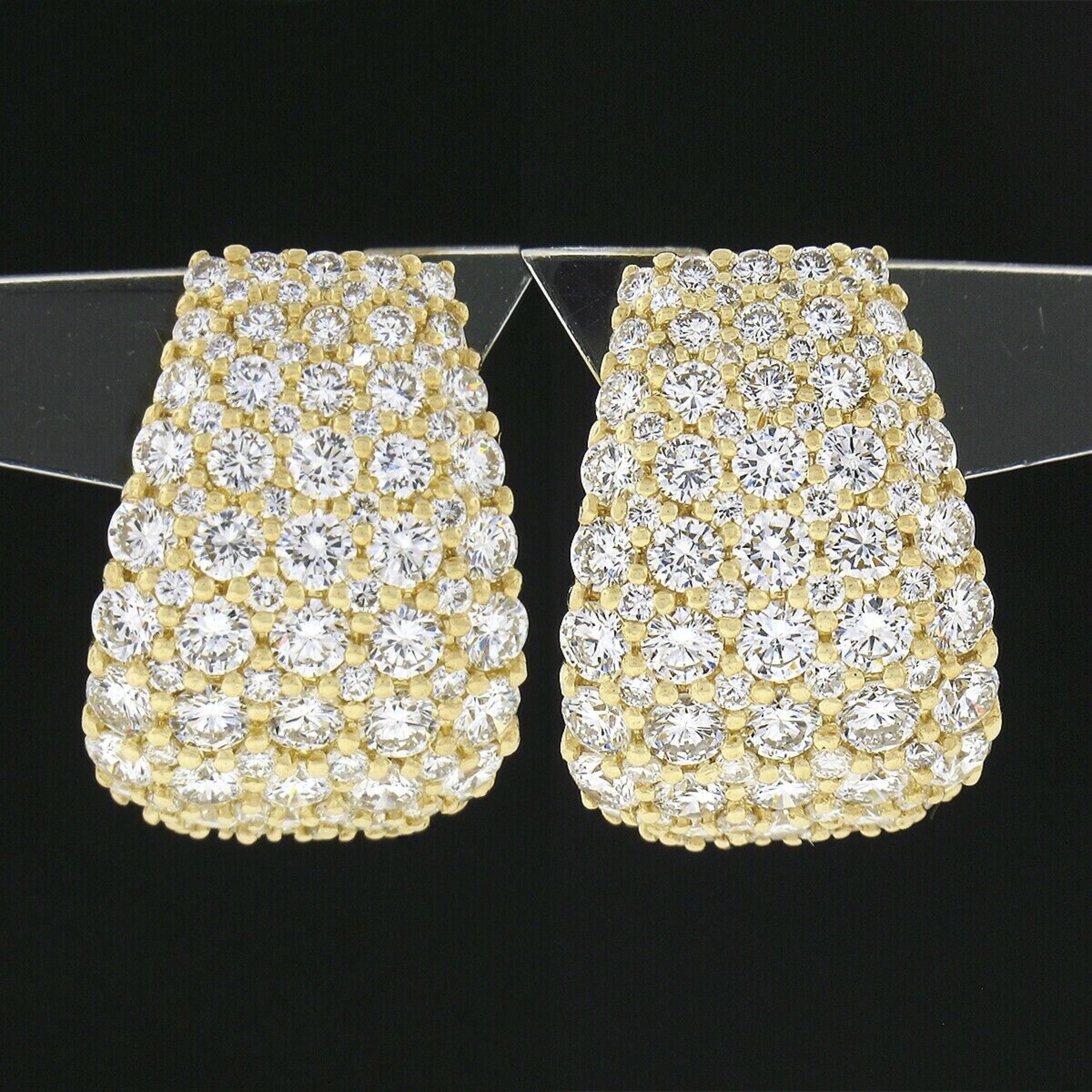 Here we have an exceptional pair of cuff earrings by NOVA which are crafted in solid 18k yellow gold and feature a wide design completely drenched in super fine quality diamonds throughout their front. These stunning round brilliant cut stones total
