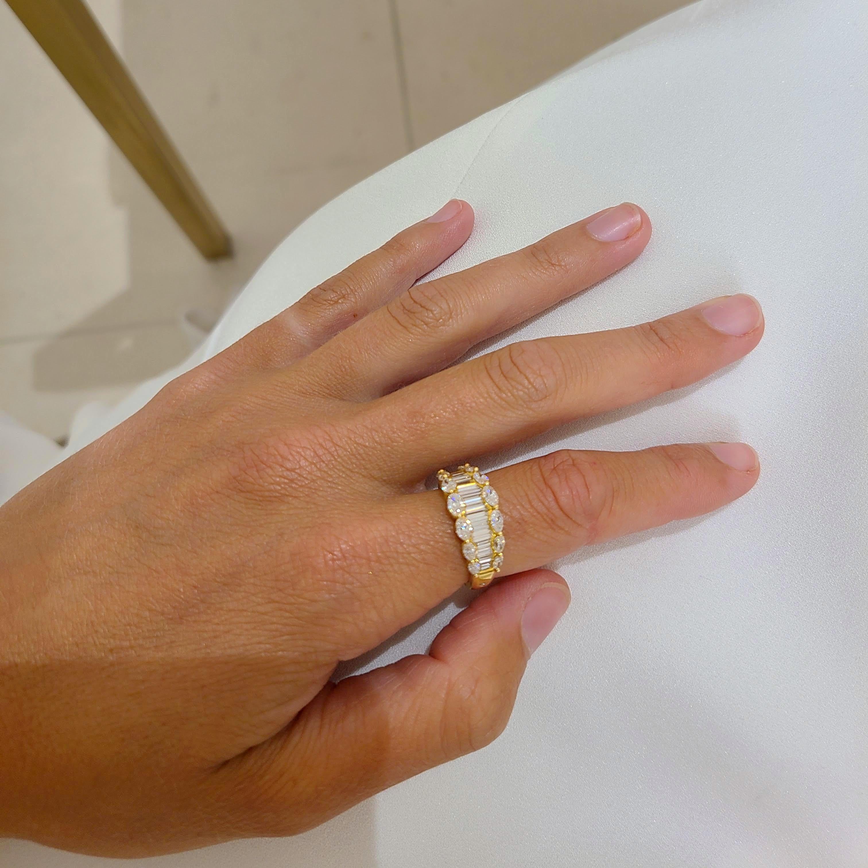 Beautiful 18 karat yellow gold ring set with Baguette and Marquise cut Diamonds. The Baguettes are set vertically, and the Marquise are set horizontally. The diamonds taper slightly for a lovely look on the finger. There is a round Diamond set in a