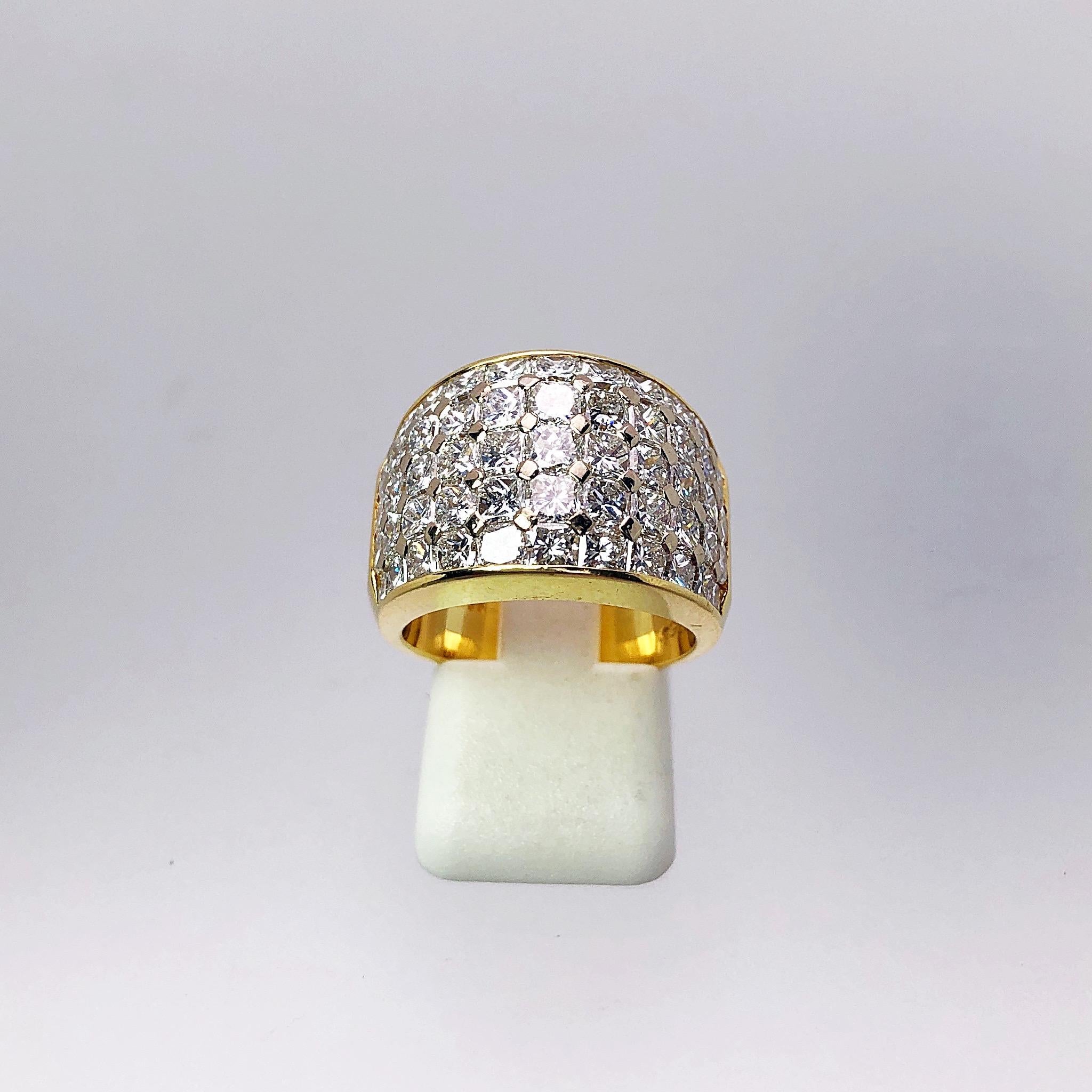 Designed by Nova, this 18 karat yellow gold ring is a showstopper with 5 rows of Princess Cut Diamonds. The Diamonds are invisibly set. The 5 rows have a slight domed taper from 14 to 11.5 mm at the Diamond section. The ring has the Nova hallmark on