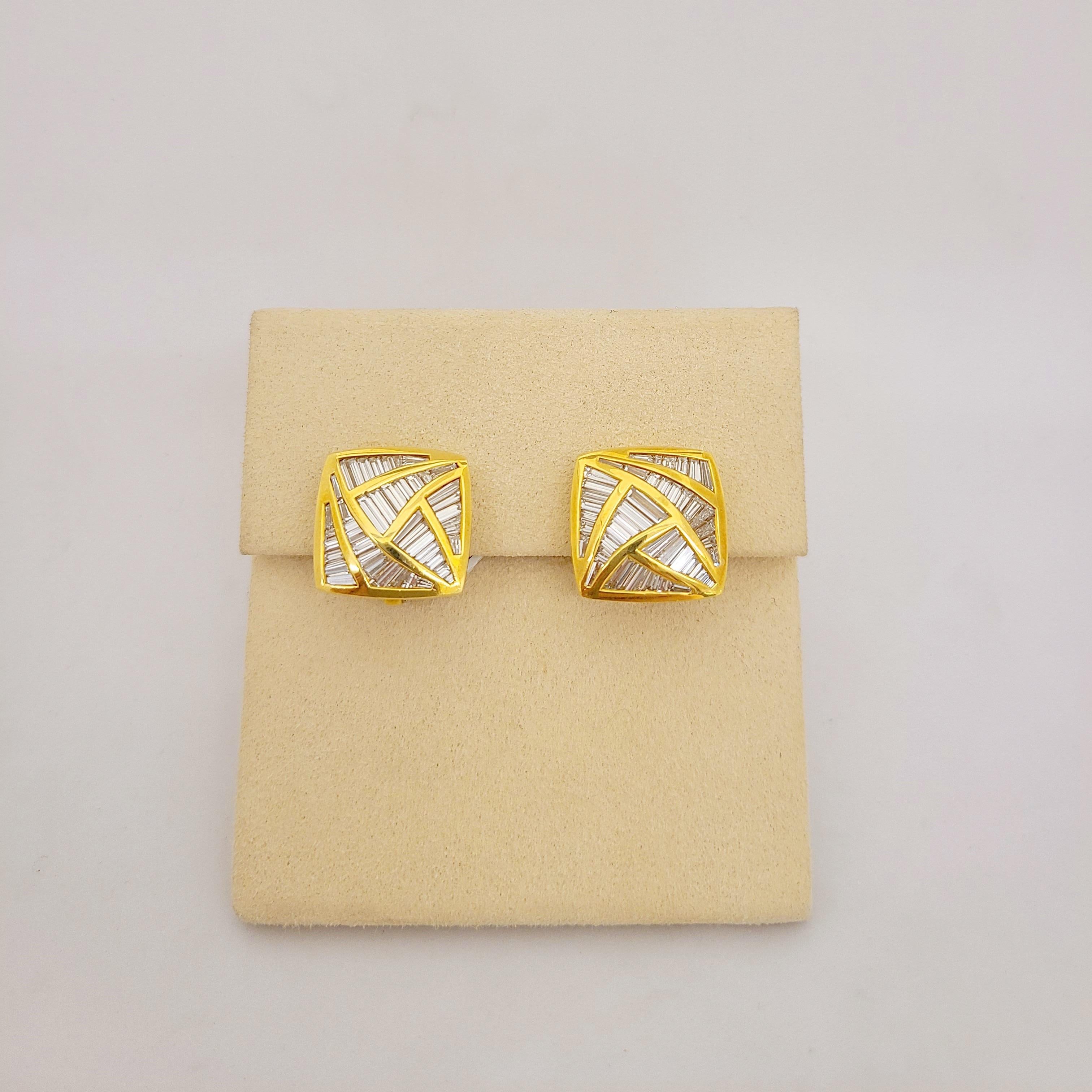 Designed by Nova Jewelry, these 18 Karat Yellow Gold Geometric designed Earrings are set with 5.29Ct. of Invisibly set baguette cut diamonds. The combination of the linear baguette cut diamond, triangular gold sections and square shaped earring make