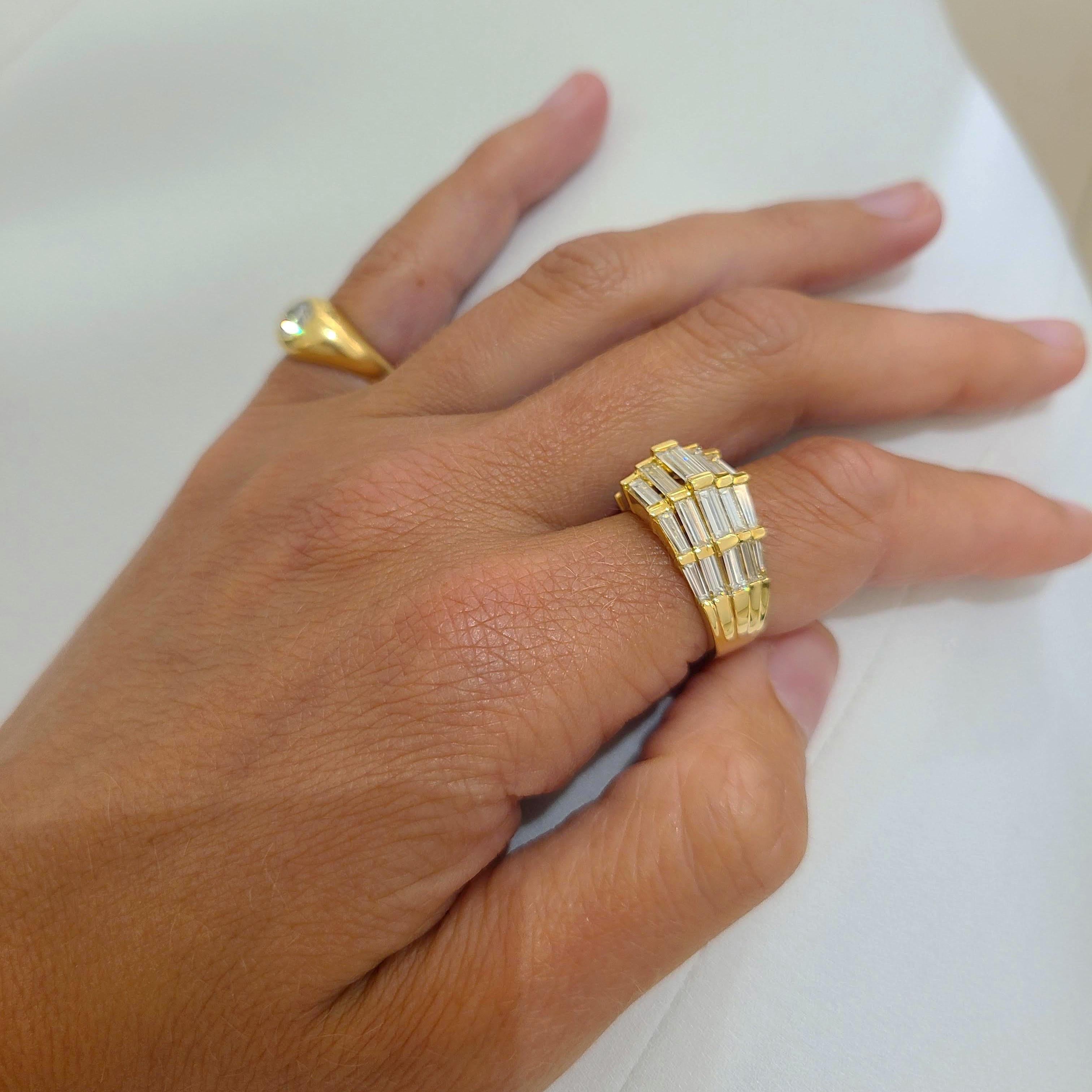 This 18 karat yellow gold ring was designed by Nova. A beautiful setting highlighting Baguette cut Diamonds set horizontally in a unique step pattern. 
Ring size 6.25 sizing options are available
The ring has a round Diamond set in a triangle on the