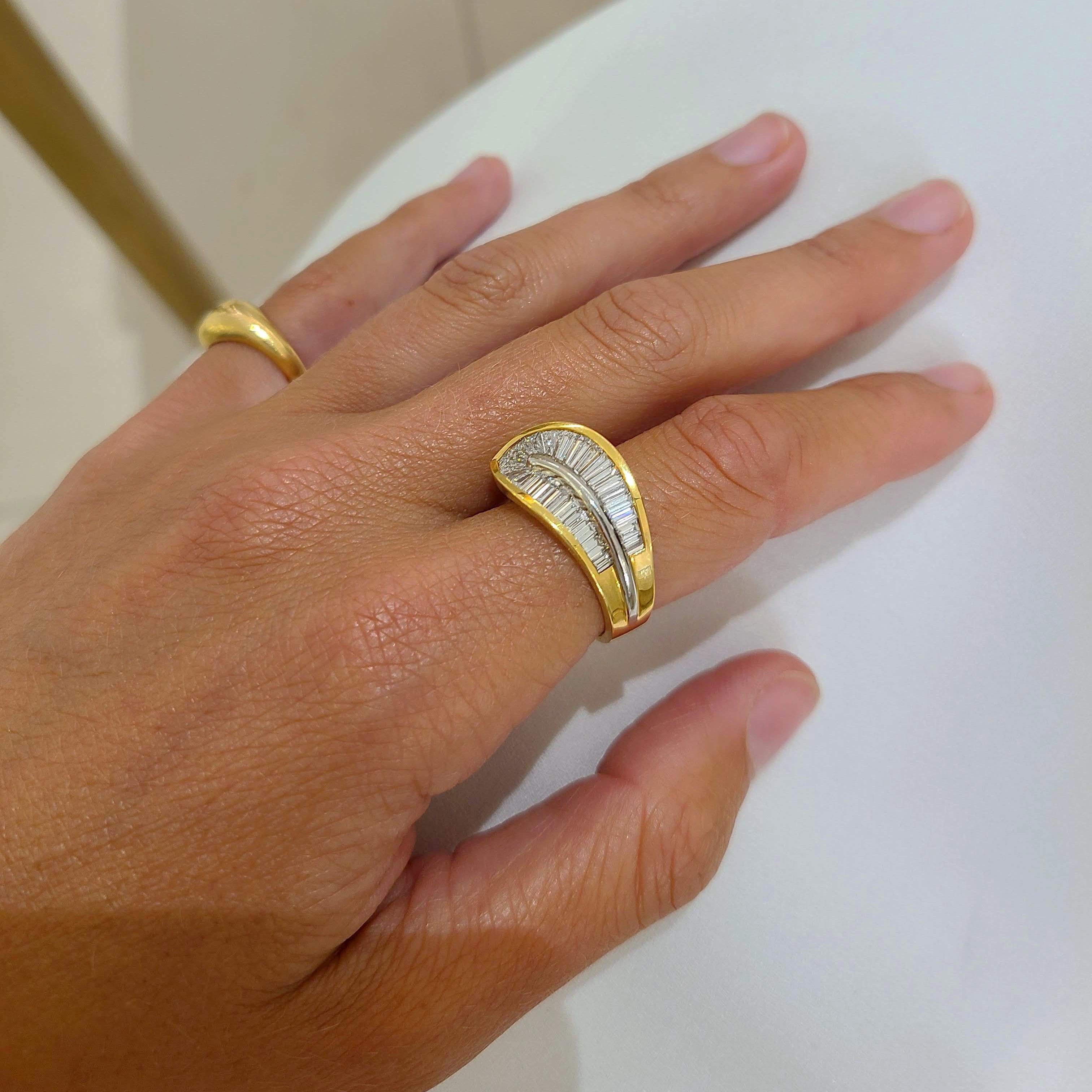 This 18 karat yellow gold and platinum ring was designed by Nova. A unique setting highlights the tapered Baguette Cut Diamonds which are set in two rows that gracefully wrap around the finger.
Ring size 6  sizing options are available
The ring has