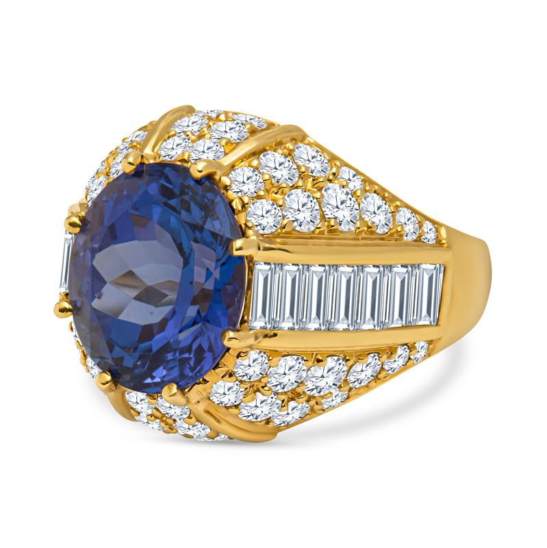 This estate ring from Nova features a 9.14 carat oval cut natural tanzanite accented by 3.50 carat total weight in round and baguette diamonds set in 18 karat yellow gold. This ring is a size 9.5 but can be resized upon request. Stamped Nova 18K.