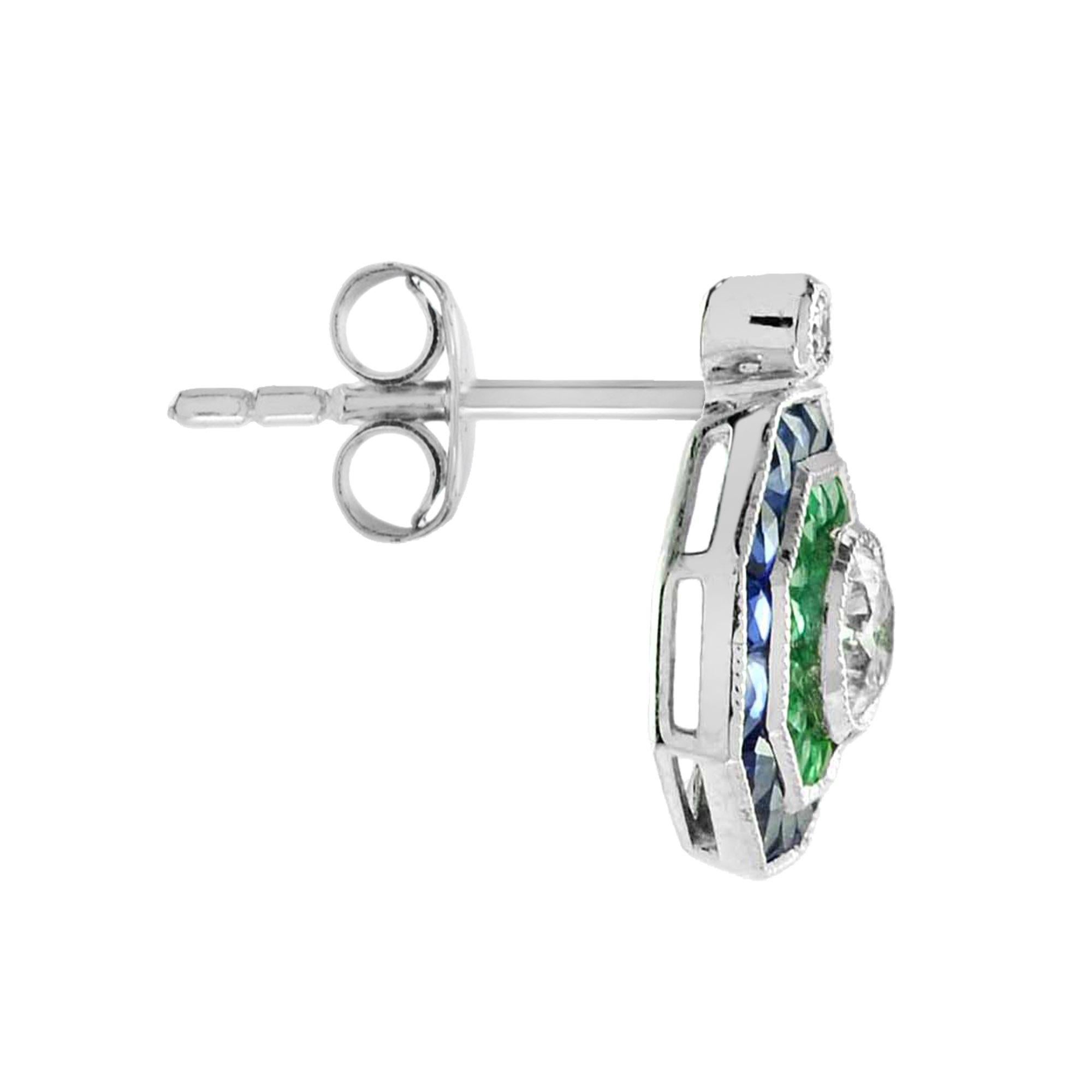 A glamorous Art Deco inspired target cluster earrings bezel set with stunning brilliant cut diamonds, framed in an octagonal border of French cut emeralds and further sapphires which case around the edge. 

Information
Style: Art Deco
Metal: 18K