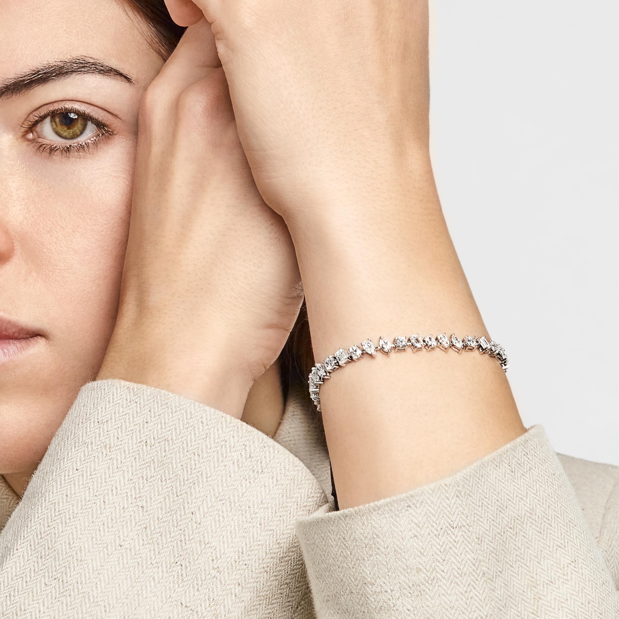 Jewels Aficionado offers this exquisite display of artistry and elegance. The Nova tennis bracelet features a stunning mix of multi-shaped diamonds totaling 6.98 carats. Set in 18K White Gold with a refined 3-prong setting, this diamond tennis