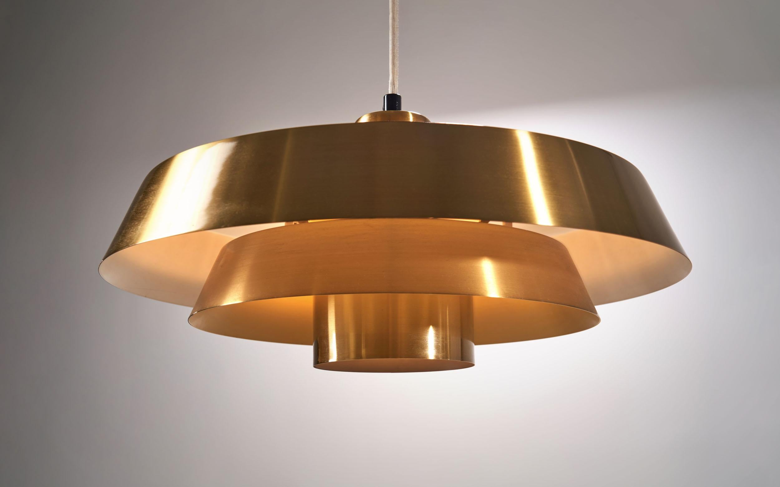 This famous Nova pendant by Danish designer Jo Hammerborg for the Danish lighting company Fog & Mørup is one of the most recognizable Danish lighting designs.

This lamp is made of solid brass with a beautiful yellow hue on the inside of the