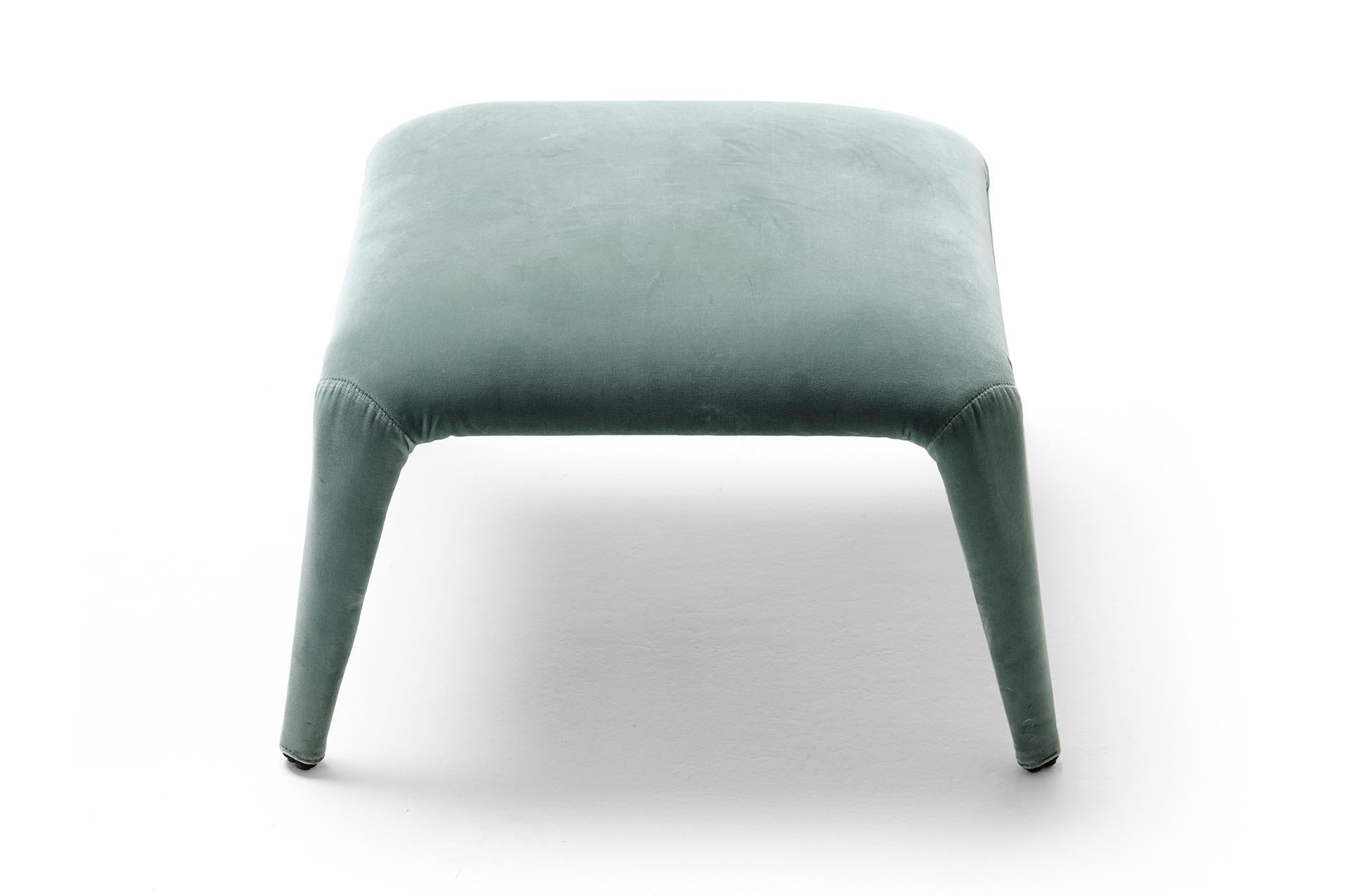 The Nova pouf is made to go with our homonymous lounge chair. It is a light-weight textile ottoman with a precious look and a fully removable fabric cover. The internal structure is a minimal metal tube skeleton that supports the elastic straps and
