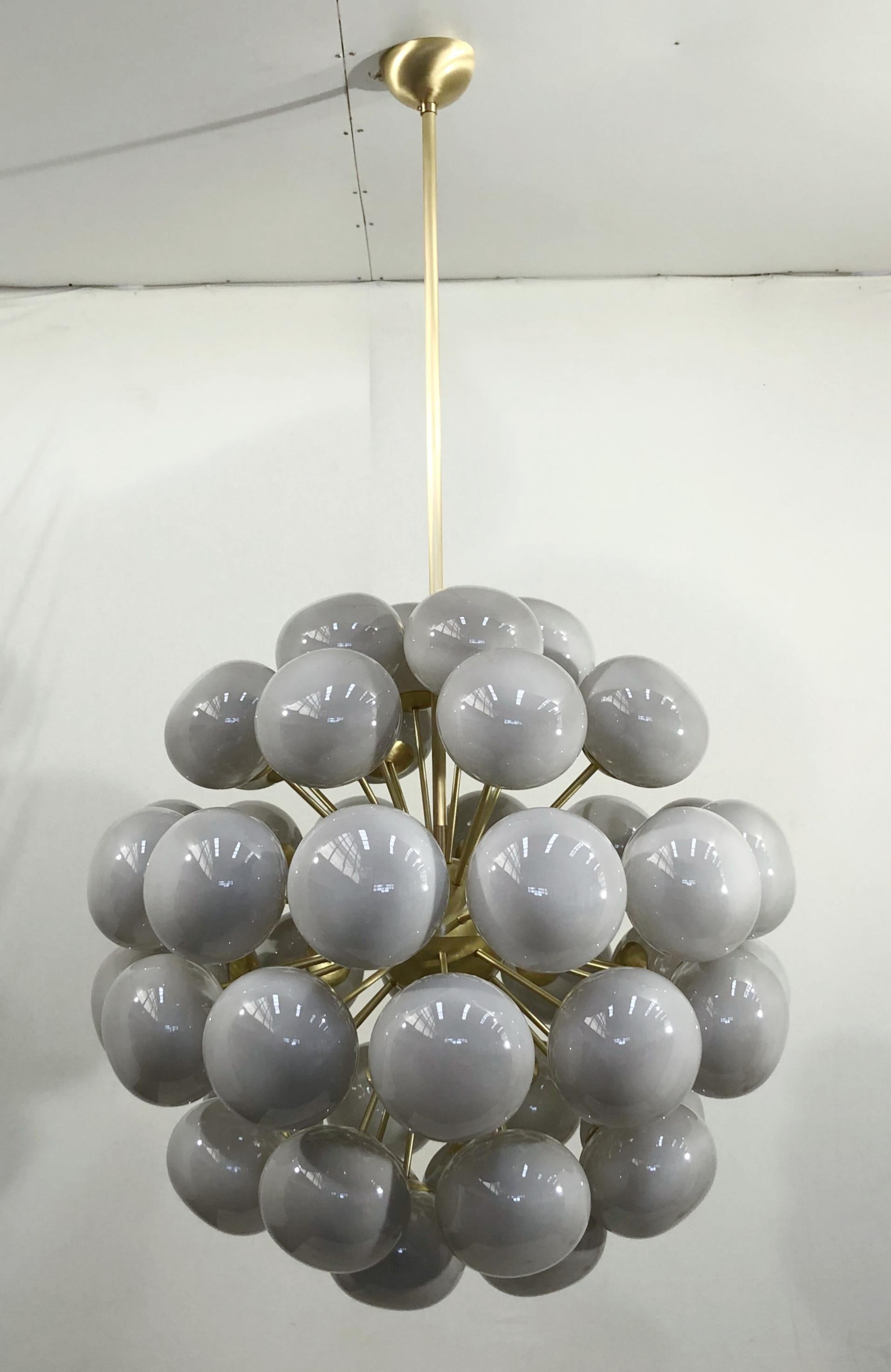 Italian sputnik chandelier with 48 gray Murano pebble glass shades mounted on brass frame / Designed by Fabio Bergomi for Fabio Ltd / Made in Italy
48 lights / E12 or E14 type / max 40W each
Measures: diameter 38 inches / height 38 inches plus rod