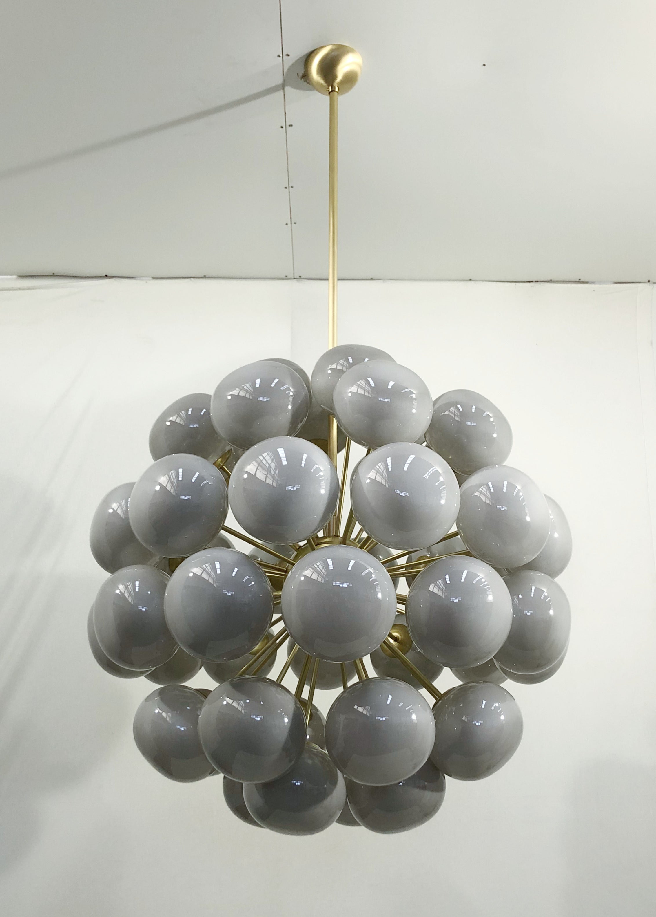 Italian sputnik chandelier with 48 gray Murano pebble glass shades mounted on brass frame / Designed by Fabio Bergomi for Fabio Ltd / Made in Italy
48 lights / E12 or E14 type / max 40W each
Measures: Diameter 38 inches, height 38 inches plus rod