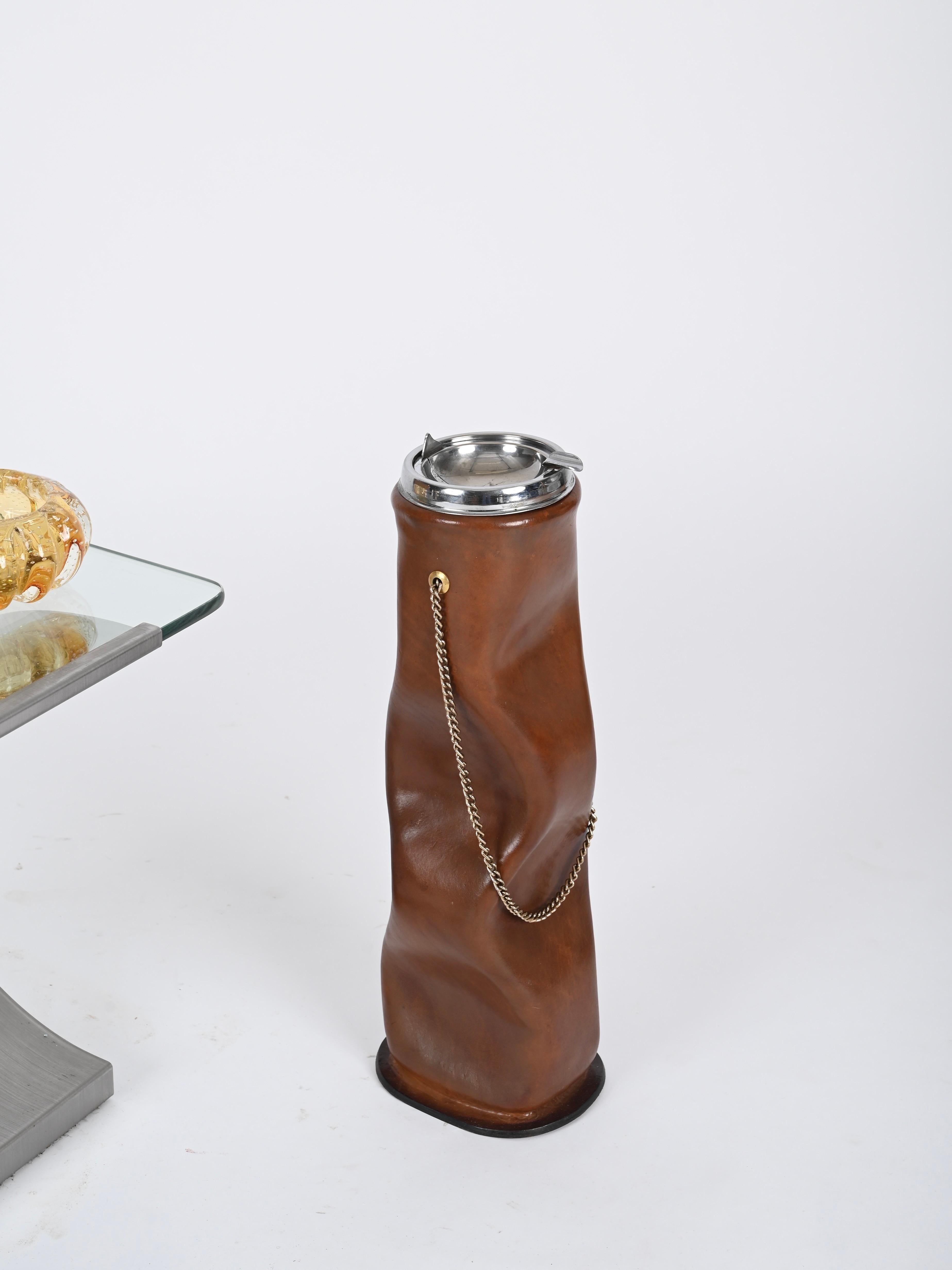 Stunning floor standing ashtray fully made in a thick Italian leather, chromed metal and completed by a stylish brass chain. This incredibly stylish and charming ashtray was made by Nova Tecno in Italy during the 1970s, clearly inspired by the
