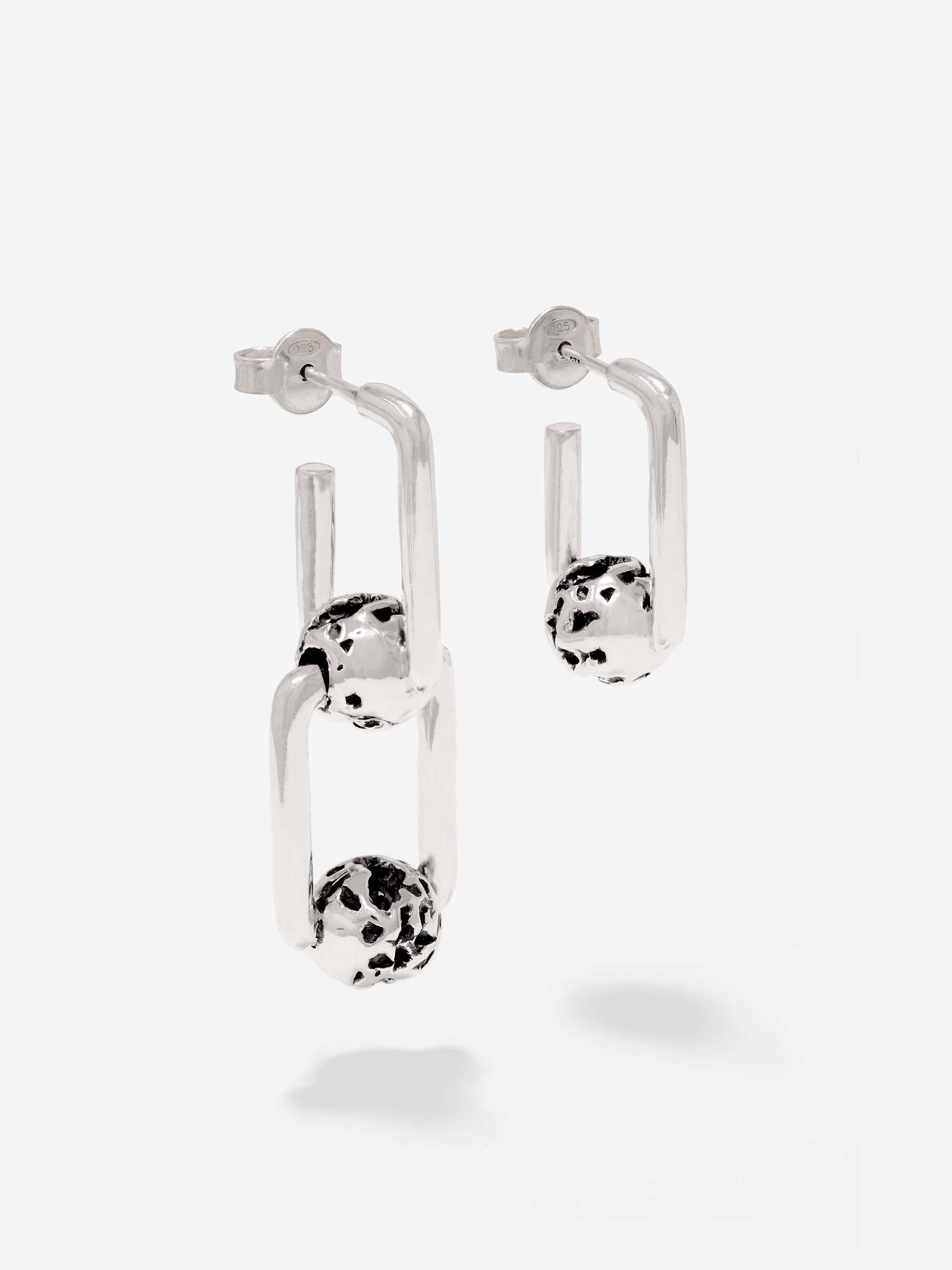 CAPTIVE - Made of solid sterling silver, the Novae Asymmetrical earrings make a solid statement when worn on opposite lobes or doubled up onto one.

The double chain link earring weighs 8g and the single chain earring weighs 4g. This gives a total