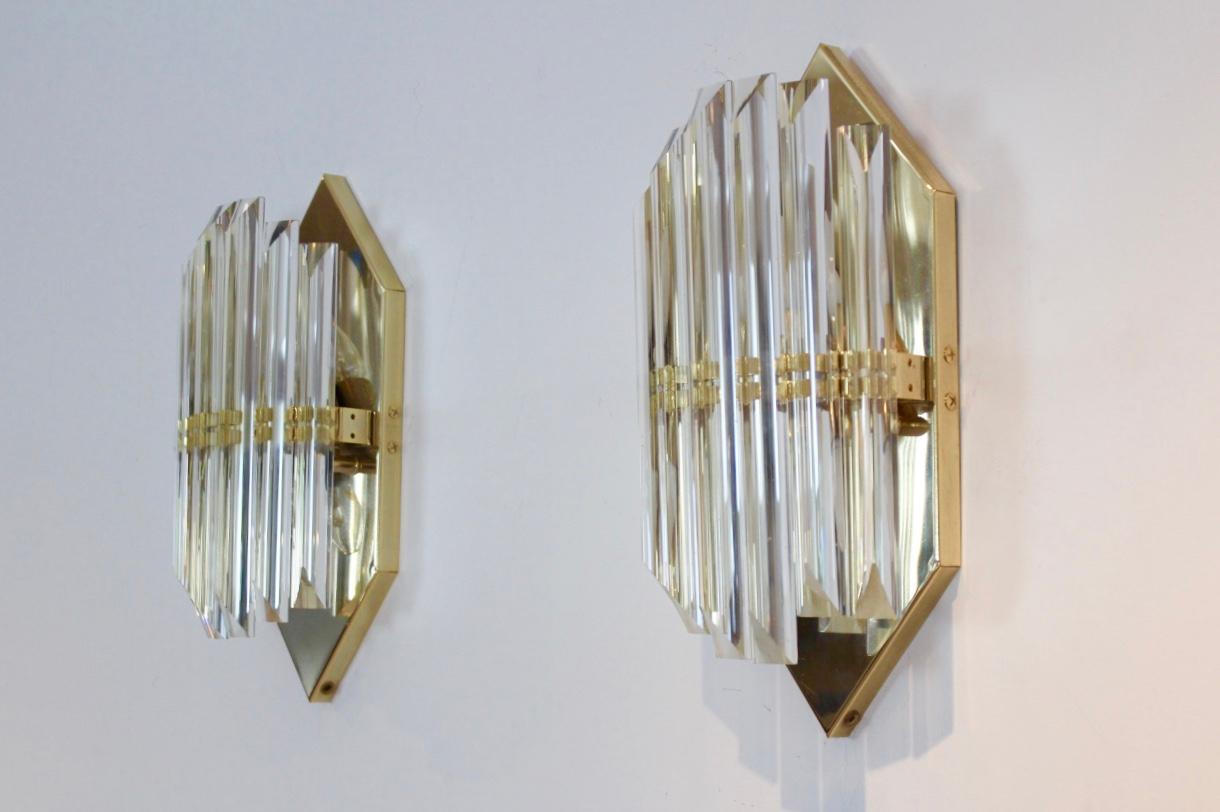 Highly sophisticated brass and Murano glass sconces produced in Italy by Novaresi Milano, ‘1980’s. Three lamps available. Each lamp has a handsome brass back plate in Hexagon shape and has a beautiful geometrical pattern with 7 long full glass