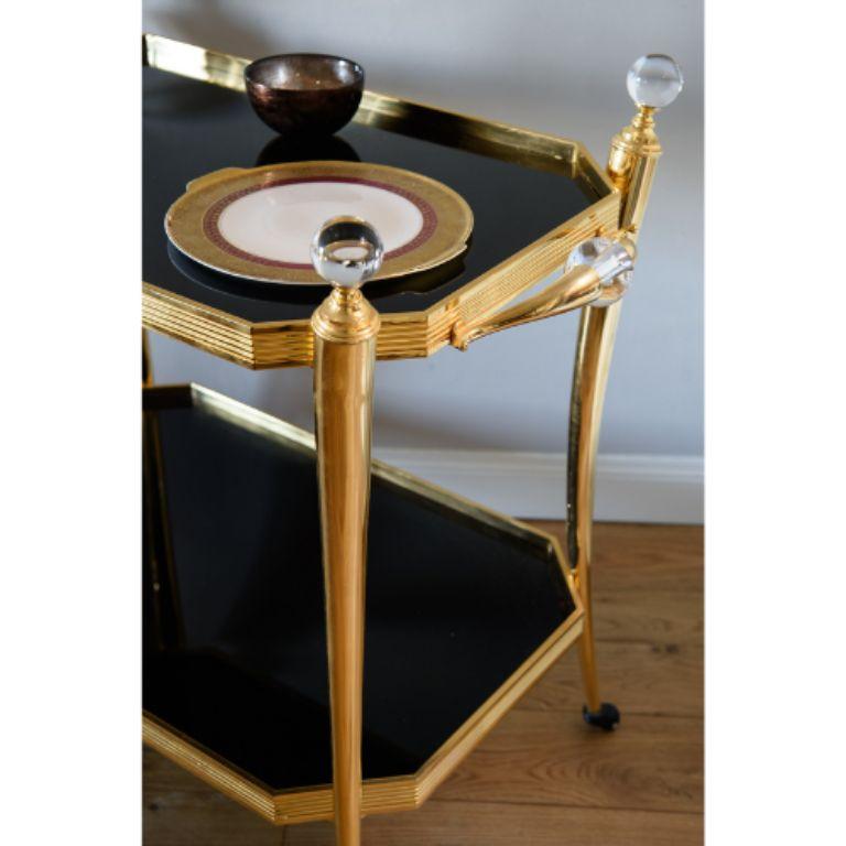 Elevate your decor with our exquisite Trolley Table, featuring a robust brass structure adorned with dazzling crystal elements and complemented by sturdy tempered glass table tops. This table seamlessly blends modern design with opulent detailing,