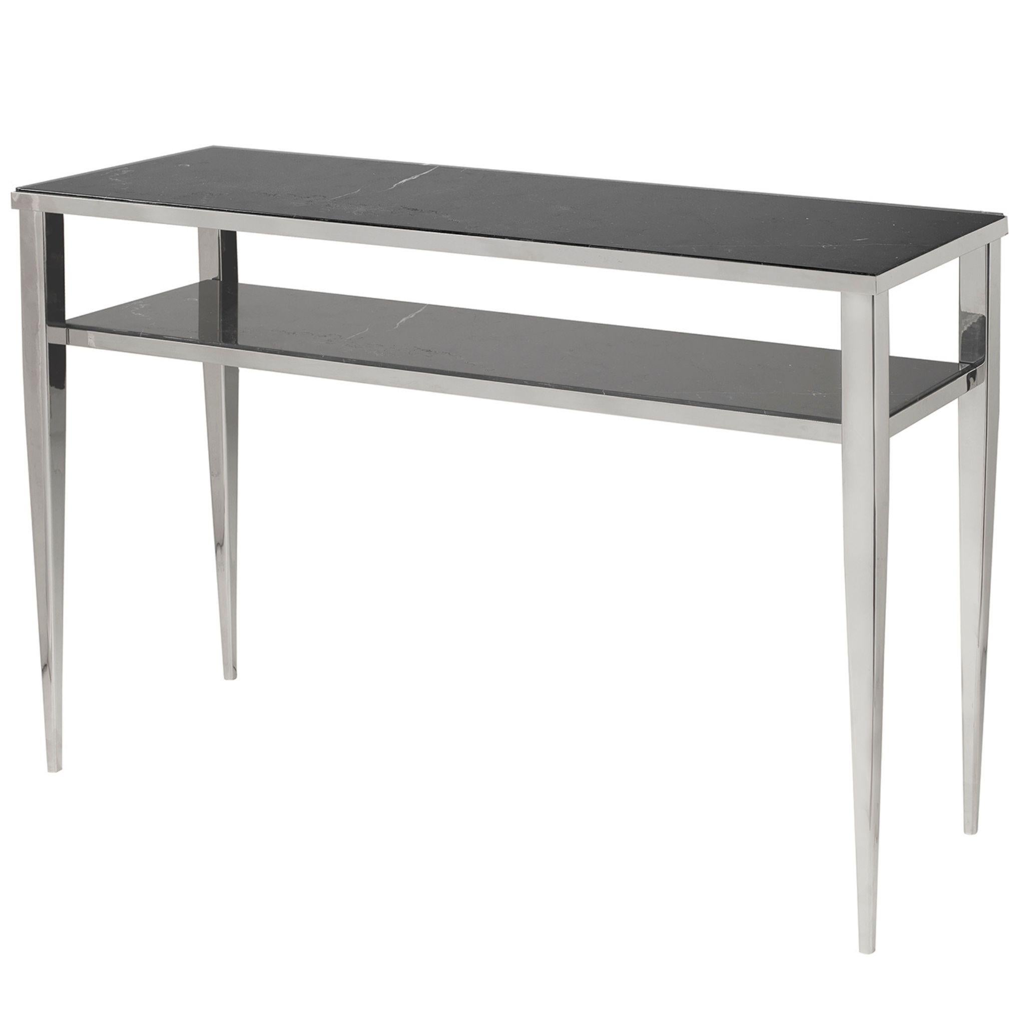 Fine and elegant, this console has a slender silhouette in brass and a double marble shelf, it belongs to the Novecento line characterized by a retro taste that refers to atmospheres of the early years of this century, in particular the design of
