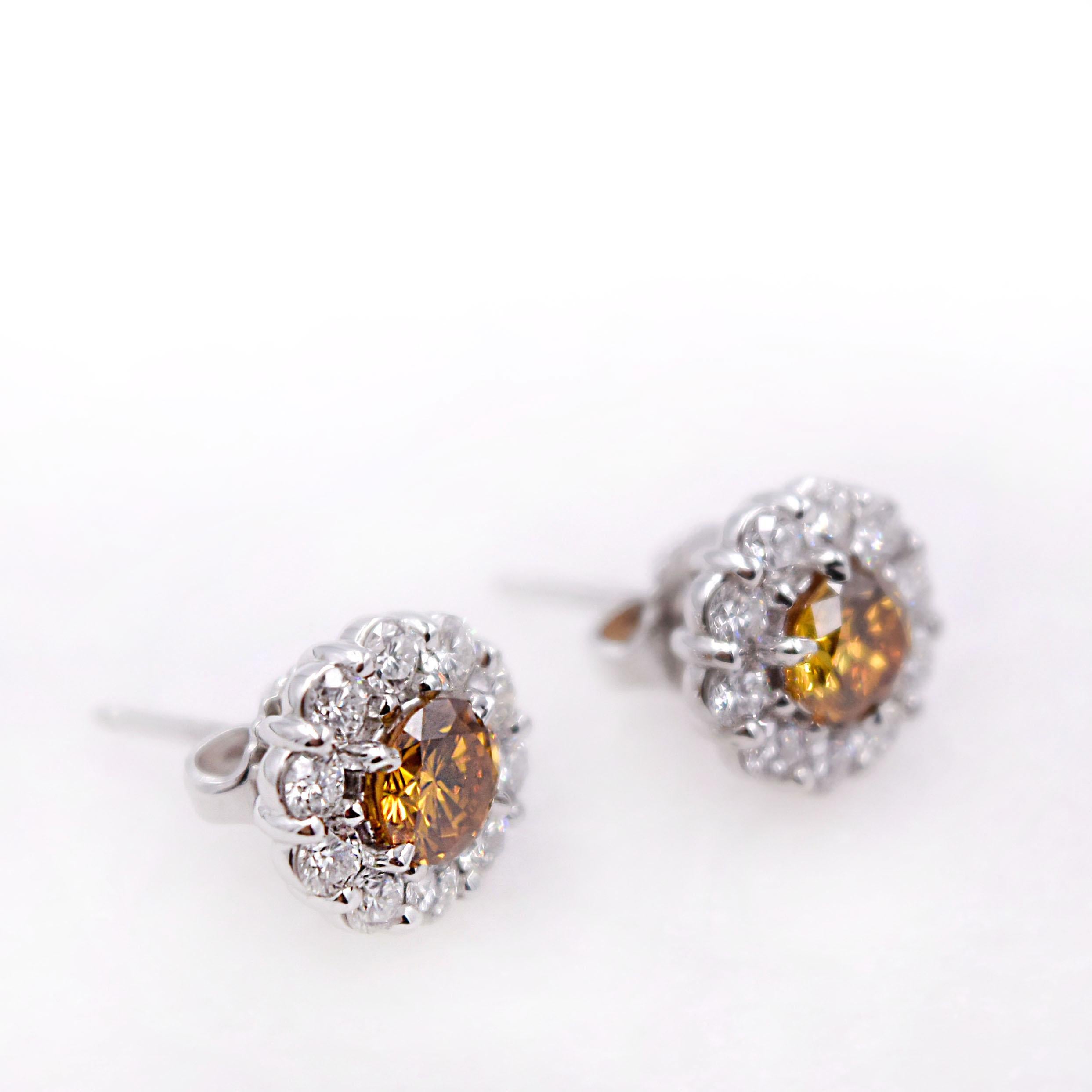 A rare GIA certified pair of colored diamond earrings:
- 0.50 Carat Fancy Deep Yellow Orange GIA#1172397231 
- 0.47 Carat Fancy Deep Brown-Yellow GIA#2175396570
A total of 20 brilliant cut white diamonds 1.0 carats.
Total diamond weight is 1.97