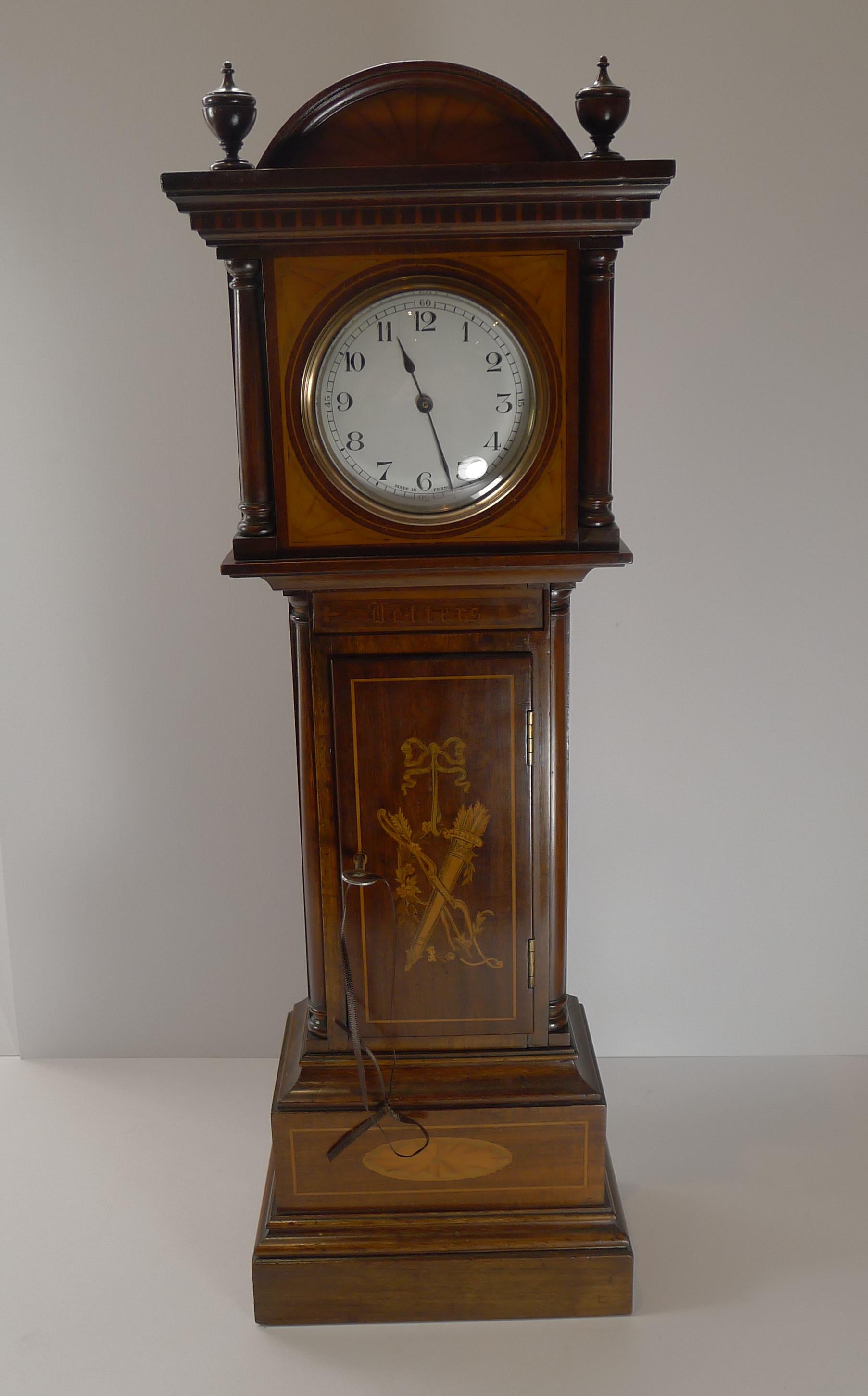 A rare, if not unique, antique English Letter box in the form of a longcase clock. 

Made from Mahogany, it is beautifully inlaid to the front; above the door at the front is the working little 