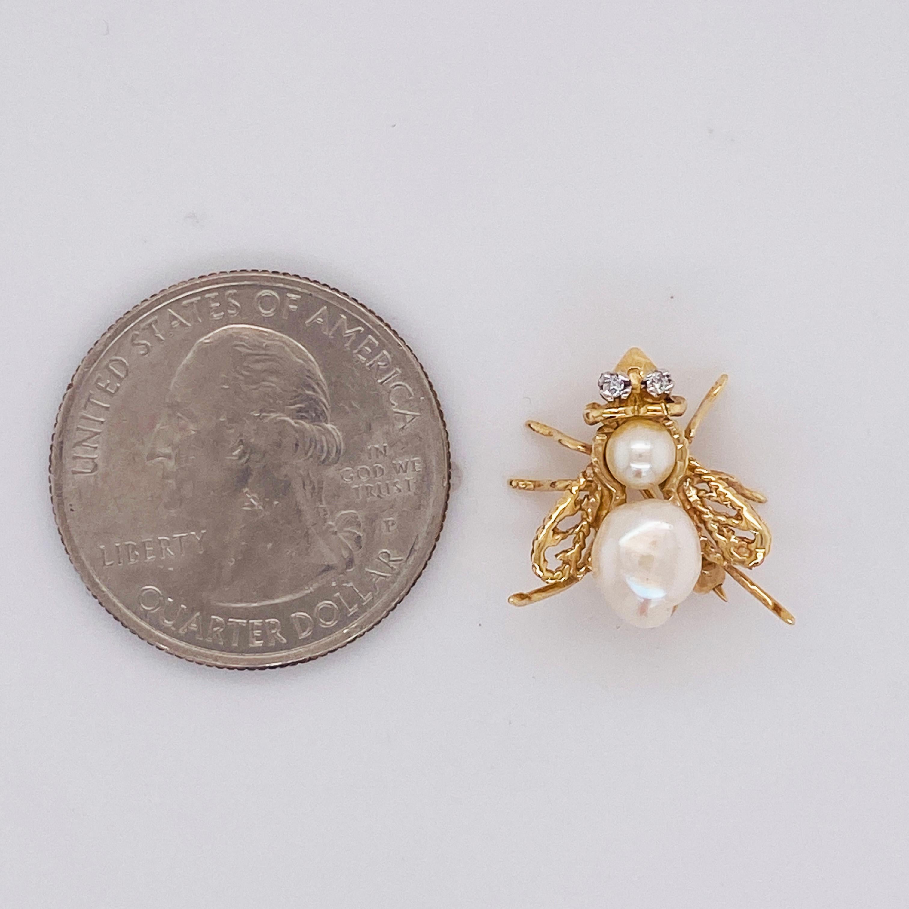 This novelty bee brooch has two genuine cultured pearls with diamonds in the eyes. It is created out of 14 karat yellow gold and was handmade. There is only one of these and it could adorn your collar or lapel with great style! The baroque shape of