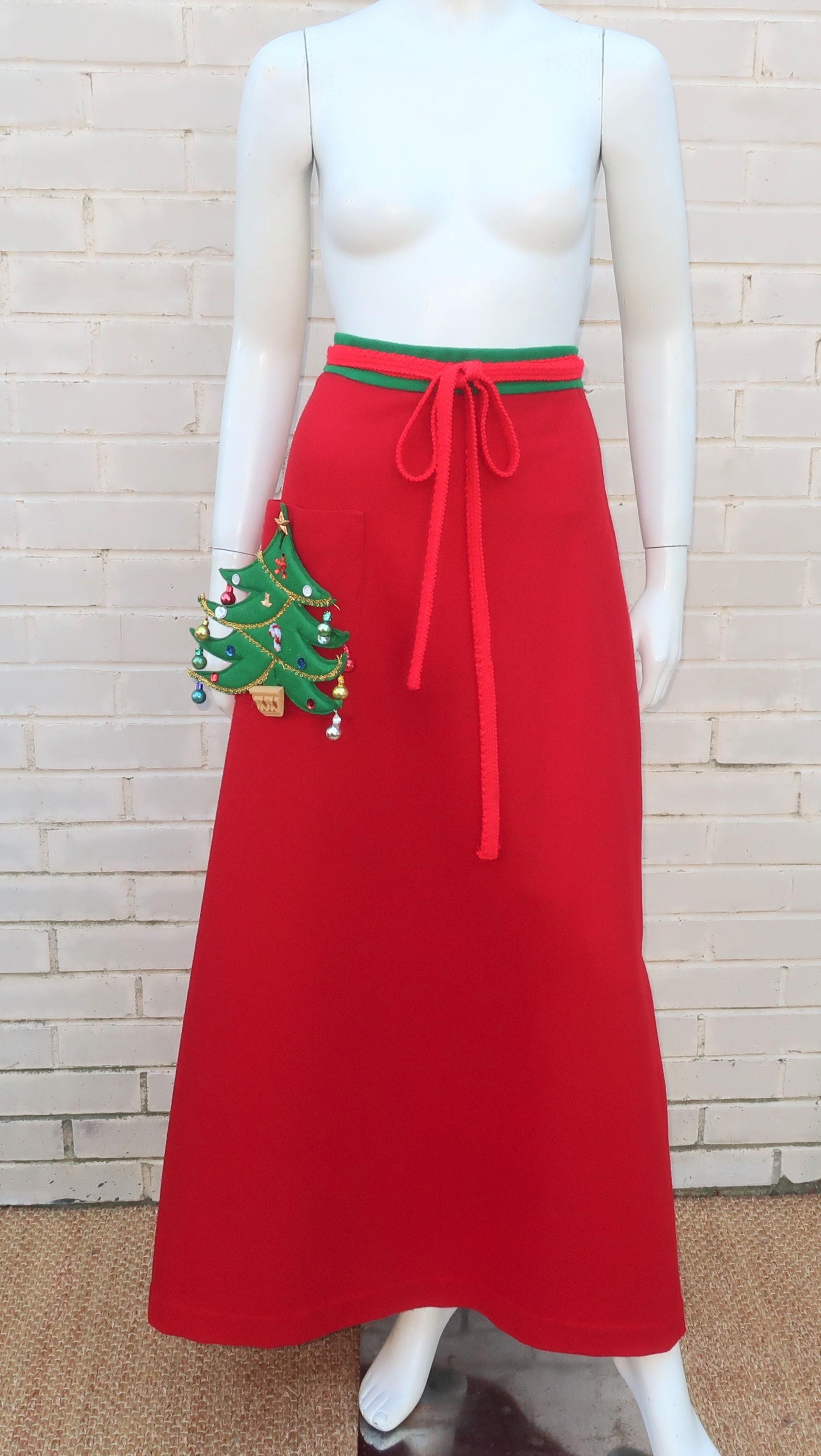 Greet guests this holiday season with a fun 1960's novelty skirt from Crabtree of Virginia.  The wrap skirt is fabricated from red wool with green trim, a red yarn waist tie and a charming removable felt Christmas tree adorned with glass ornaments