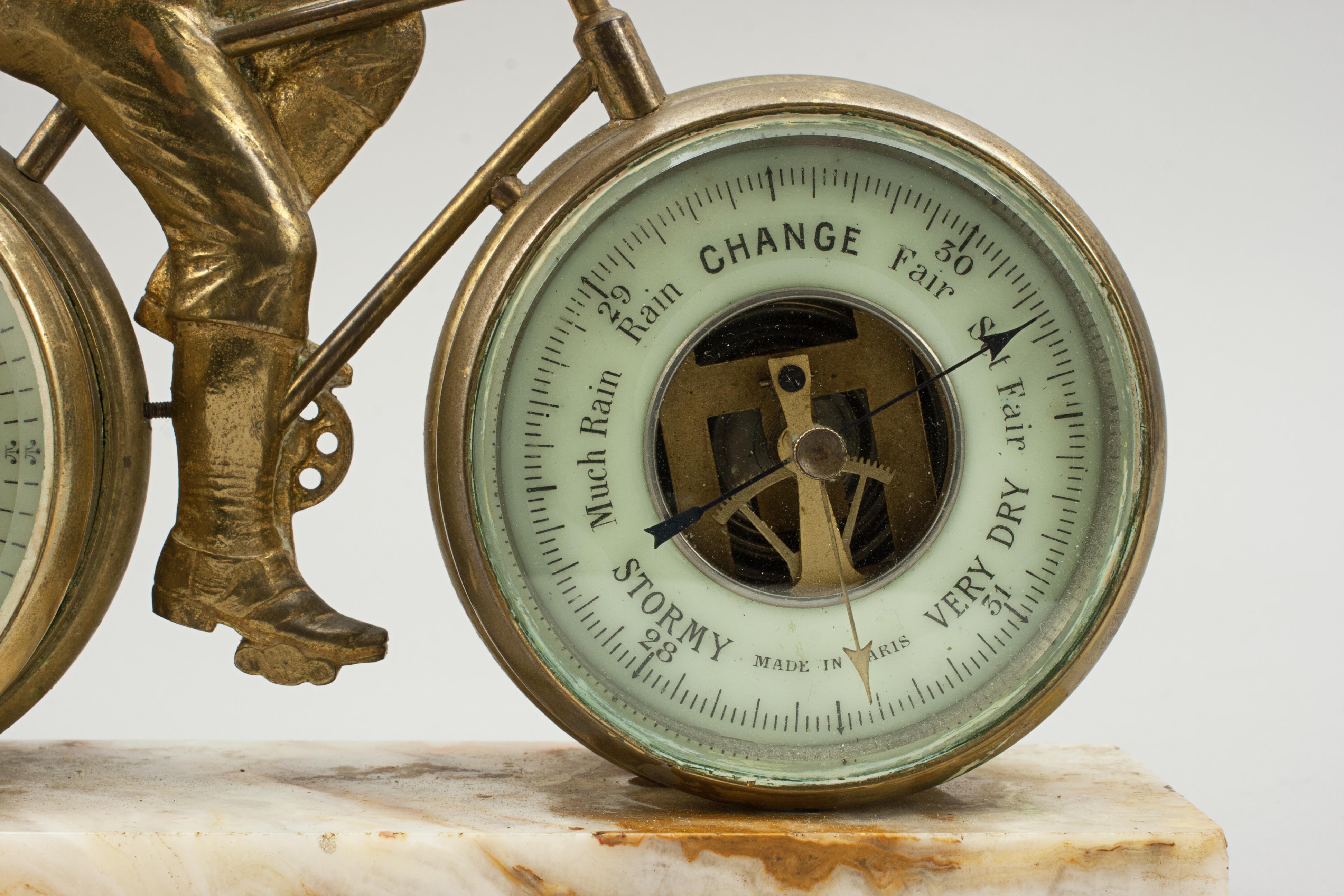 Antique cycling clock, Barometer.
A rare and very unusual late 19th century novelty bicycle clock and barometer mounted on a marble base. The gilt-brass bike has a 3
