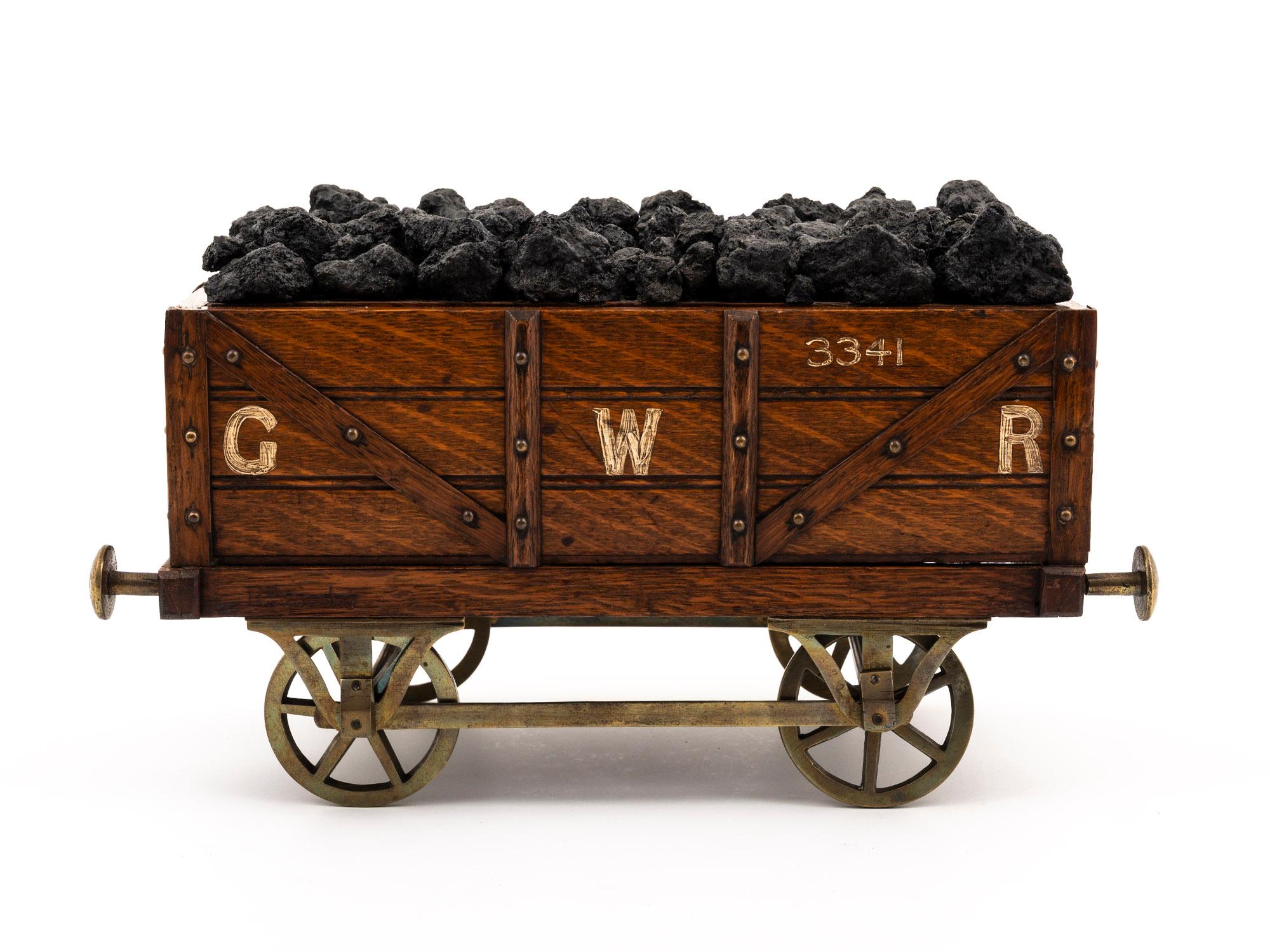Realistically Formed 

From our Boxes collection, we are pleased to offer this novelty Great Western Railway Bogie Coal Wagon Humidor. The humidor carved in oak modelled as a novelty railway bogie wagon carrying coal with working brass wheels,