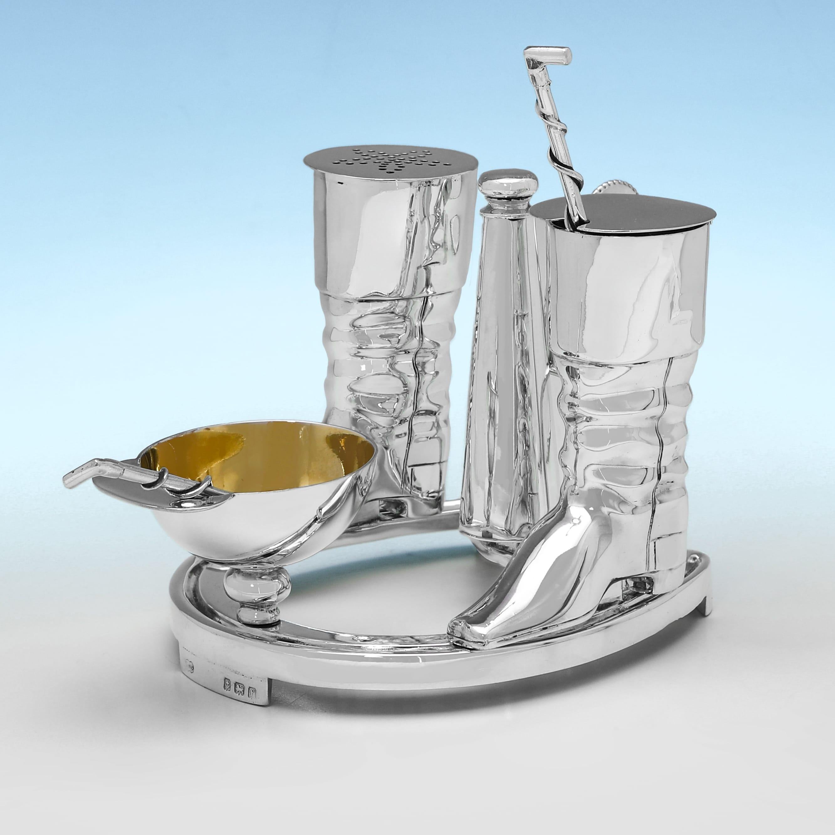Hallmarked in Birmingham in 1905 by Elkington & Co., this handsome pair of Edwardian, Antique Sterling Silver Condiment Sets, are of horse riding interest, with the pepper and mustard containers modelled as riding boots, the salt cellar modelled as