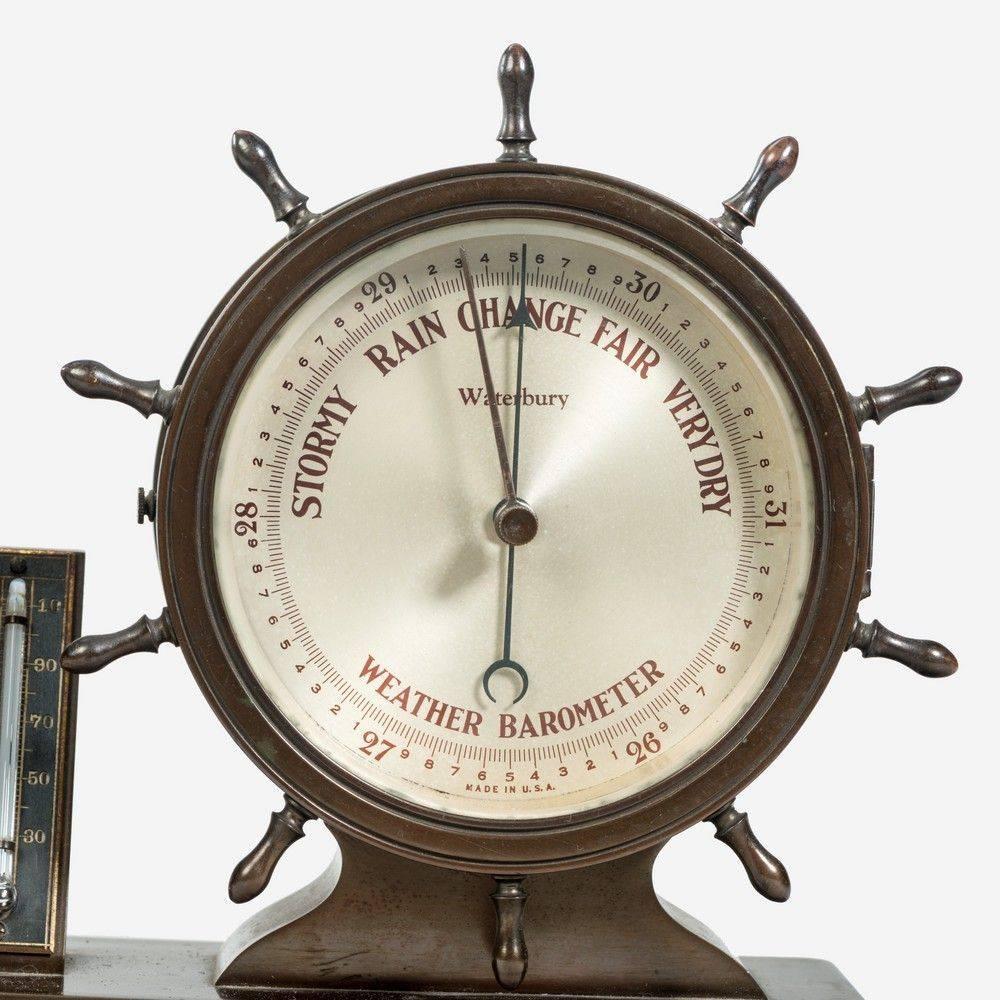 Nautical desk clock and barometer set by Westbury Clock Co., USA in the form of double ship's helm in bronzed case with an eight day movement striking the ship's watch bells.