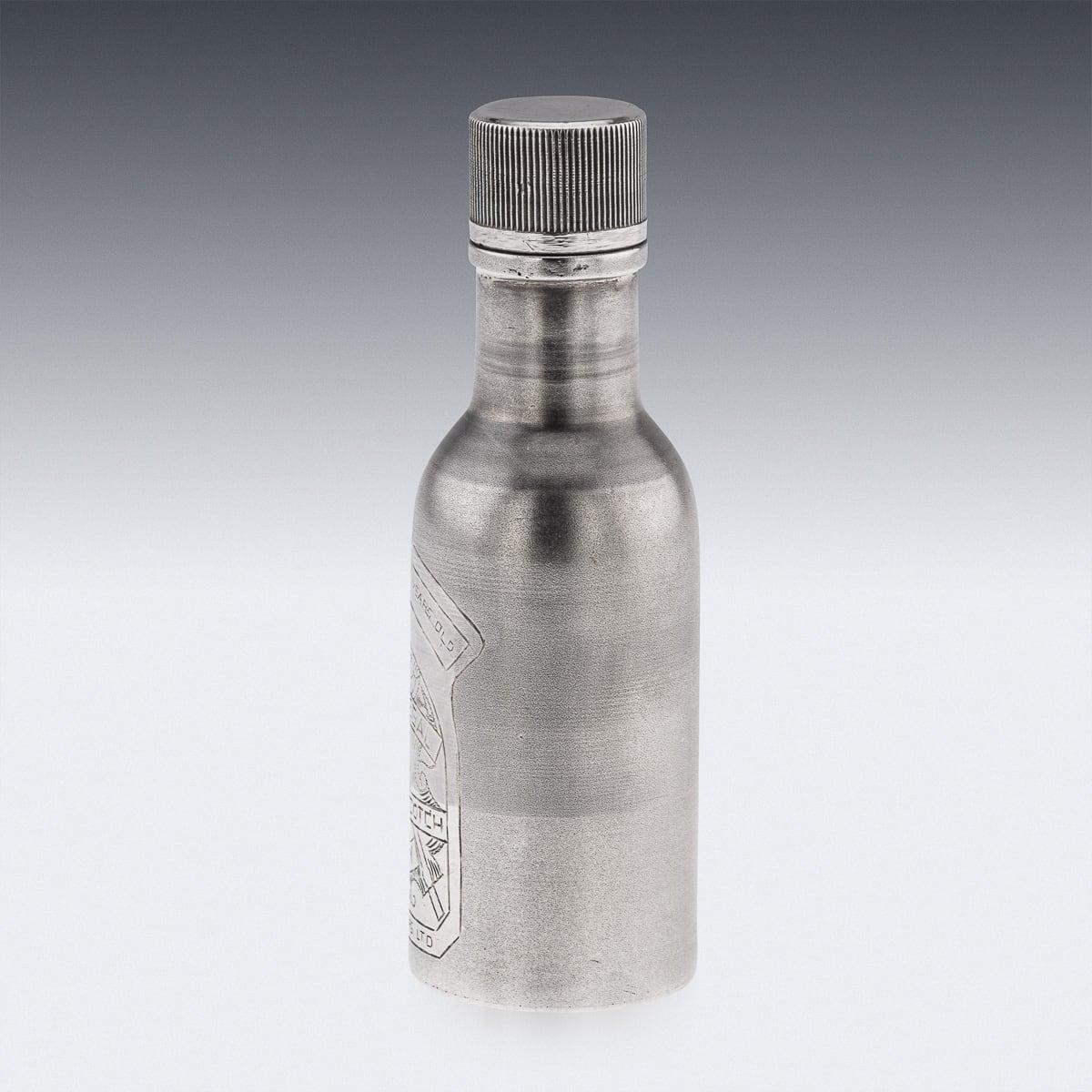 A novelty solid silver Chivas Regal whisky bottle. Of a miniature size however heavy gauge throughout. A cylindrical form with a matted finish throughout. Engraved with the label to represent a Chivas Regal 12 year bottle. The lid unscrews allowing