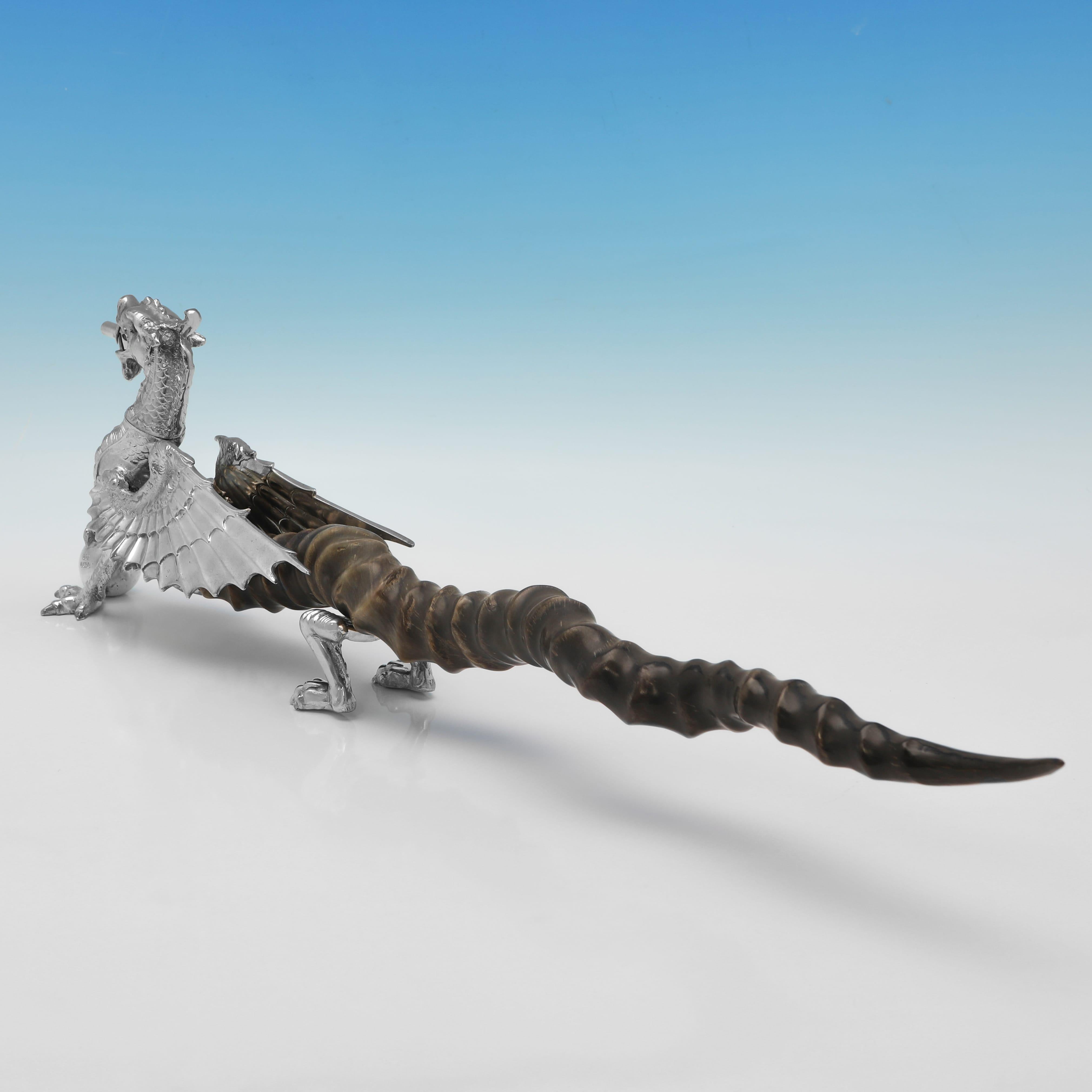Hallmarked in Sheffield in 1997, this wonderful, Elizabeth II period, Sterling Silver Cigar Lighter, is modelled as a dragon, with an Impala horn handle and glass eyes. The cigar lighter measures 5.75