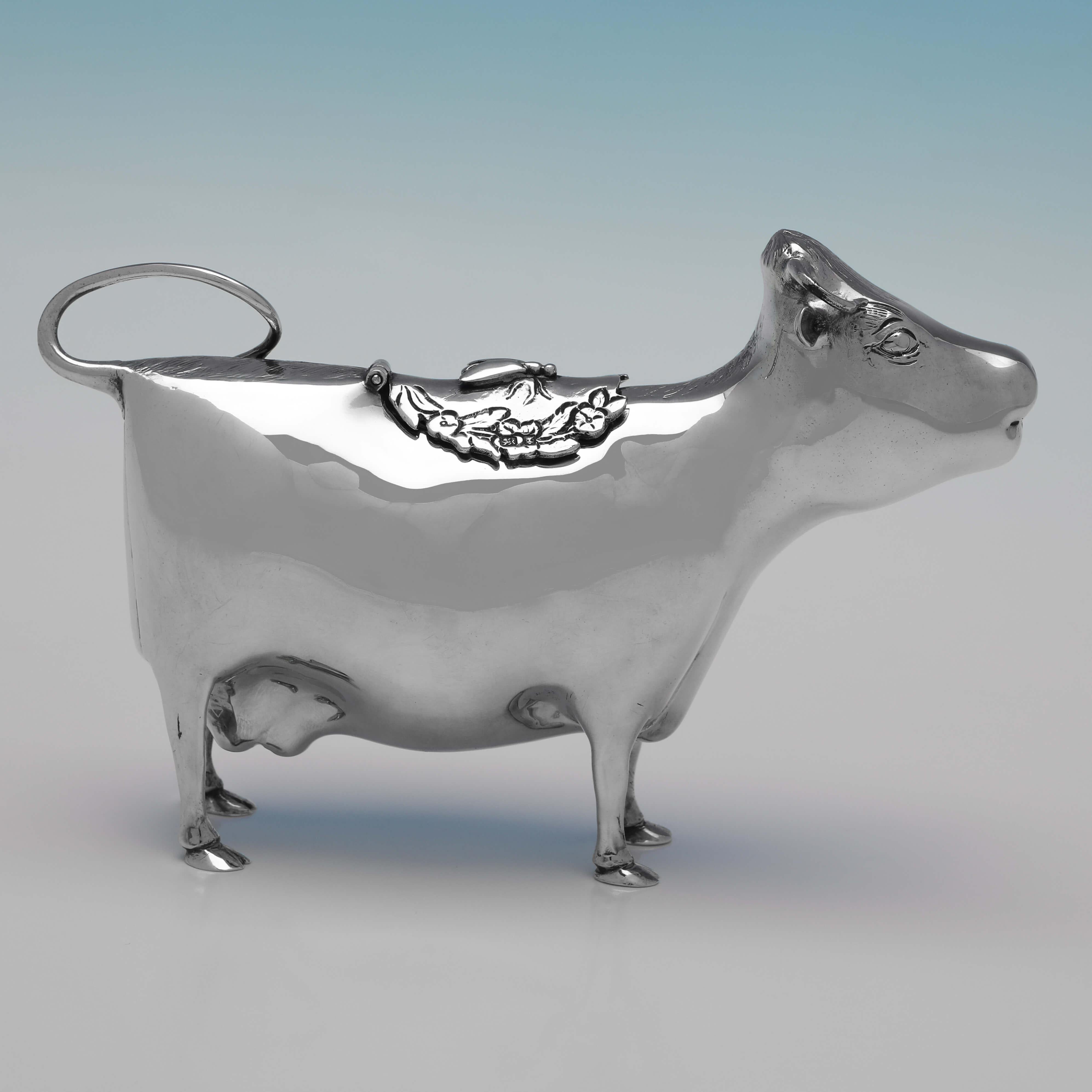 Hallmarked in London in 1977 by Richard Comyns, this handsome, Sterling Silver Cow Creamer, is a charming example. 

The cow creamer measures 4