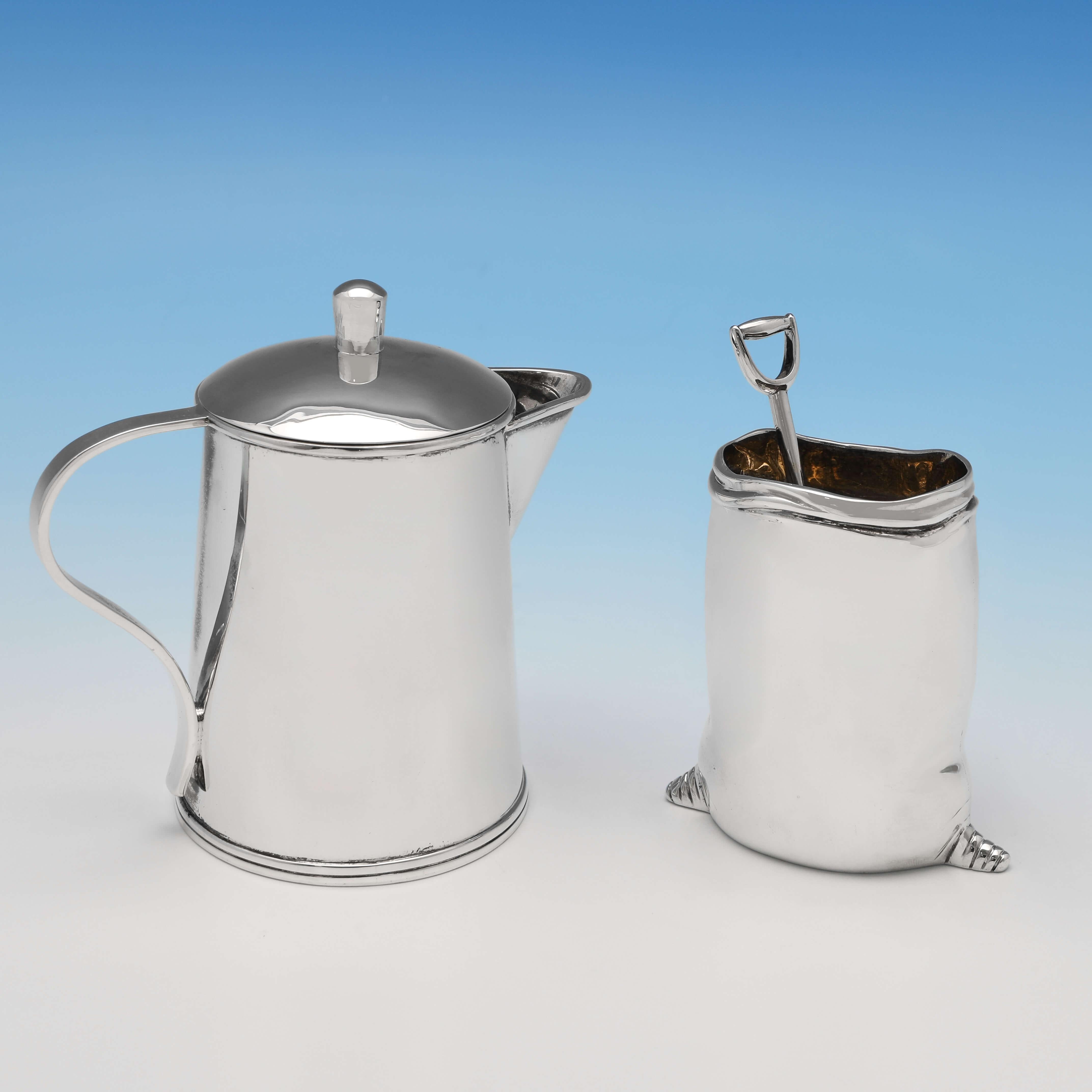 Hallmarked in Birmingham in 2000 by Thistle & Bee, this charming, Novelty Sterling Silver Sugar & Cream Set, is modelled to resemble a large agricultural cream jug and sugar bag with a shovel shaped serving spoon. 

The cream jug measures