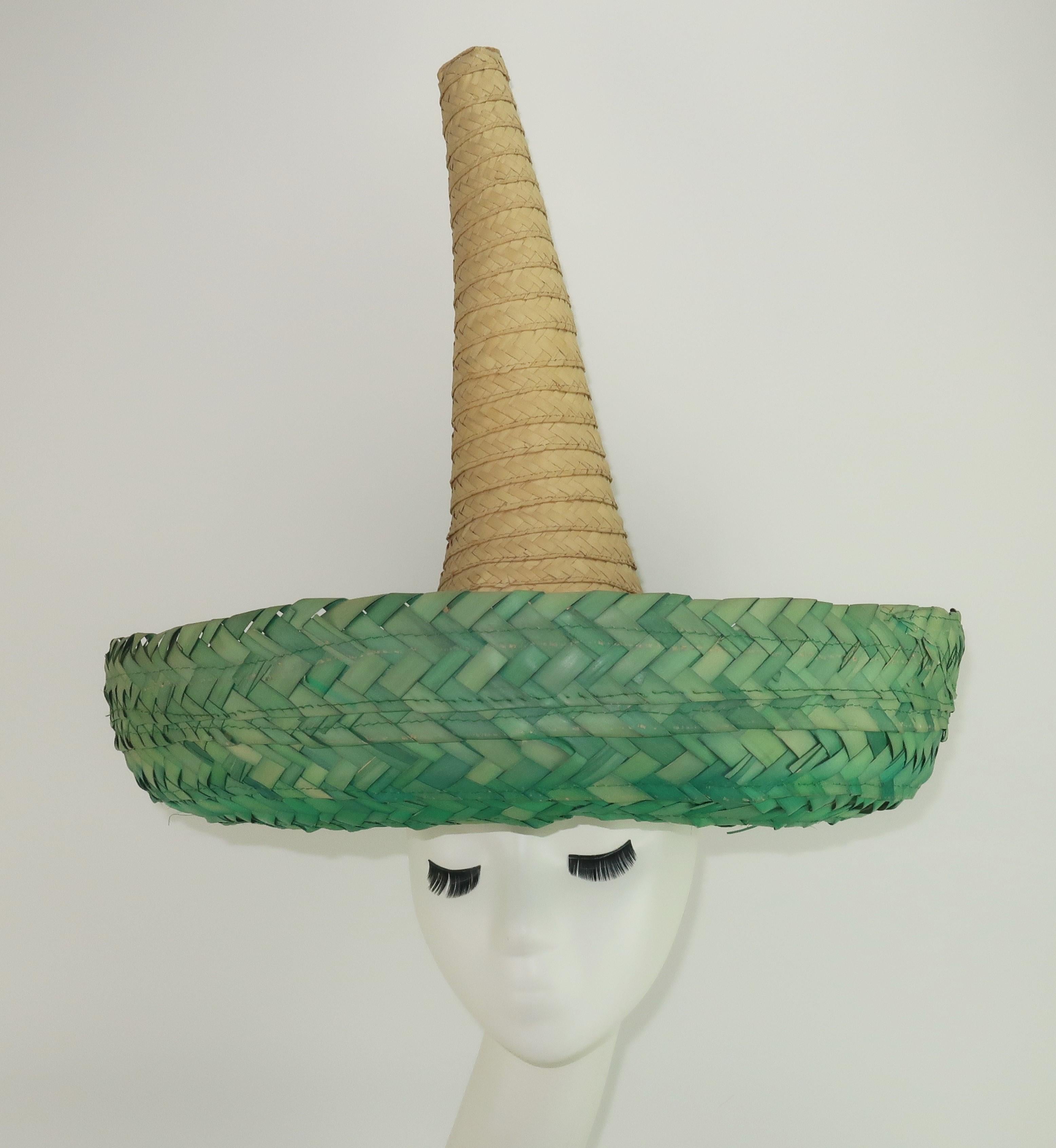 1960's novelty straw Mexican sombrero hat with a sky high crown and rounded green brim.  It is the perfect accessory for a poolside party and for those that enjoy a touch of humor in their vintage.  Marked 'Mexico' on inner rim.
CONDITION
Good