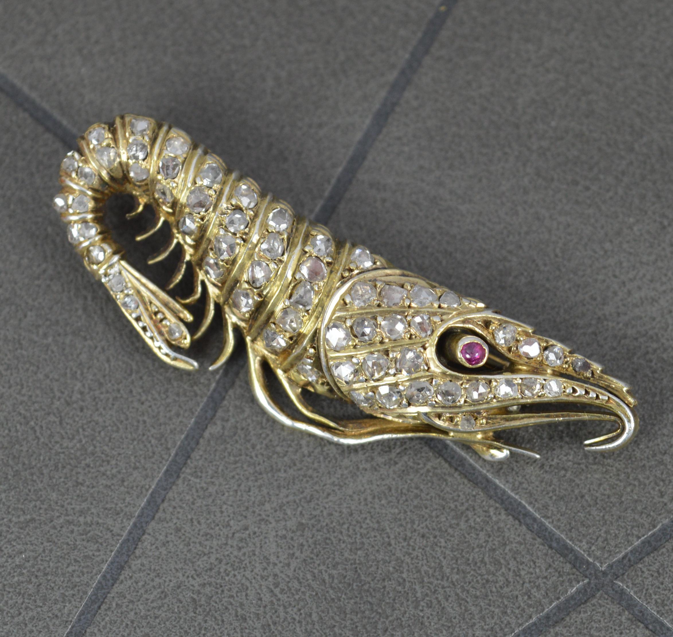 A totally captivating and unique Victorian period brooch, circa 1880.
Solid 15 carat gold example. A solid and well made example, a great gauge of gold.
Realistically designed as a shrimp. Never seen anything like it.
Set with a single ruby cabochon