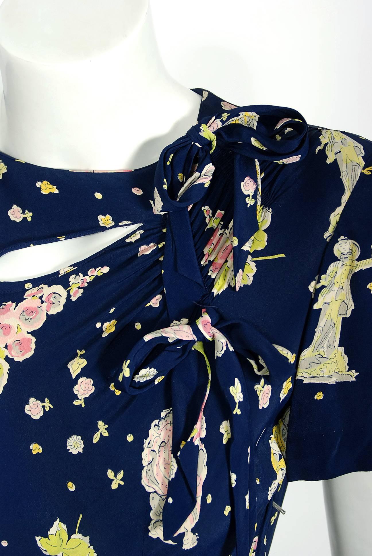 1940's Novelty Victorian Dolls Print Navy Rayon Cut-Out Bows Belted Peplum Dress In Excellent Condition In Beverly Hills, CA