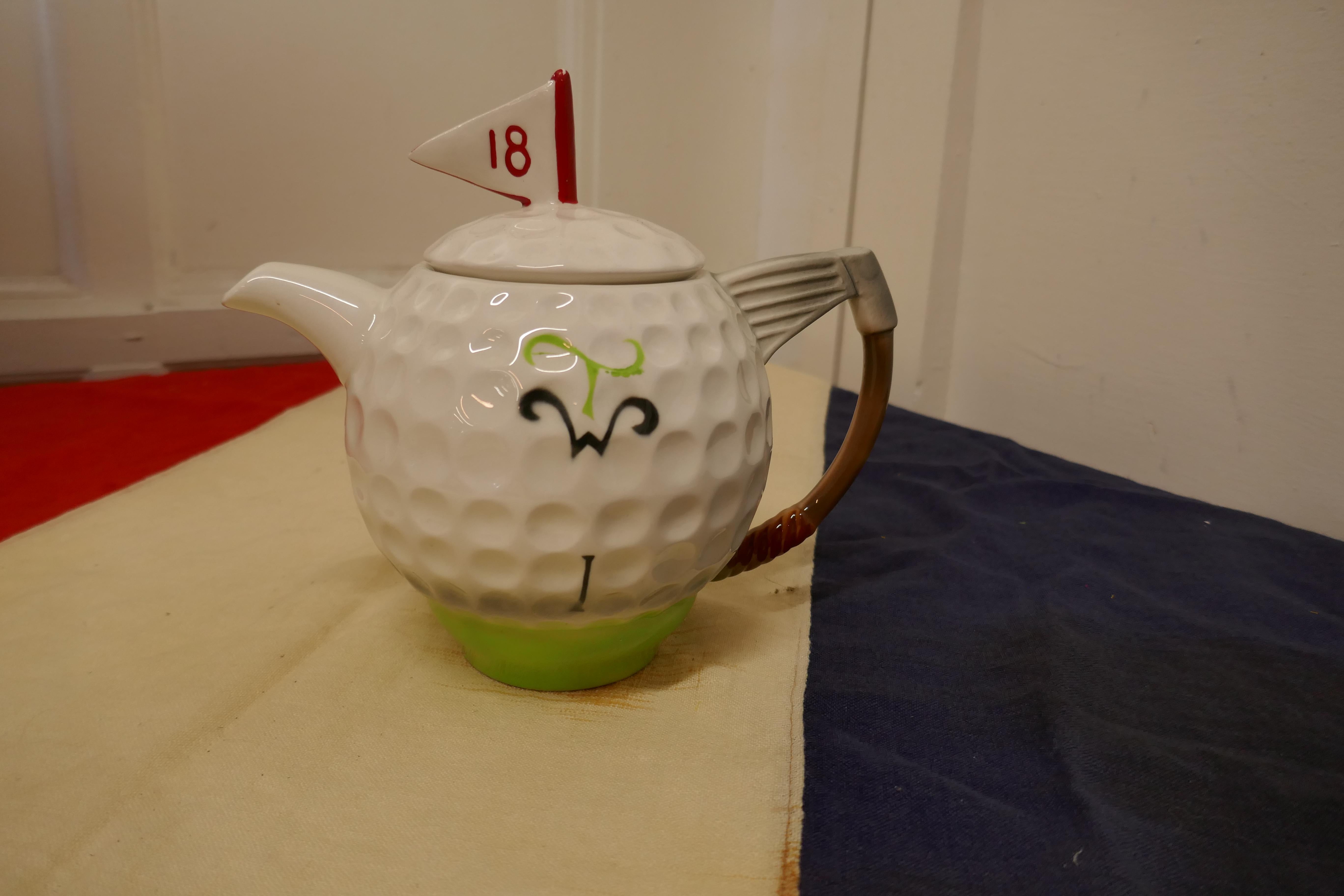 Novelty Vintage TeaPot in the form of a Golf Ball

The Pot is a 2 pint size made by the Tony Wood Studio celebrating the 19 hole
A Great Vintage piece inn good condition, a good 18th Birthday Piece

The pot is 8” tall and 9” in