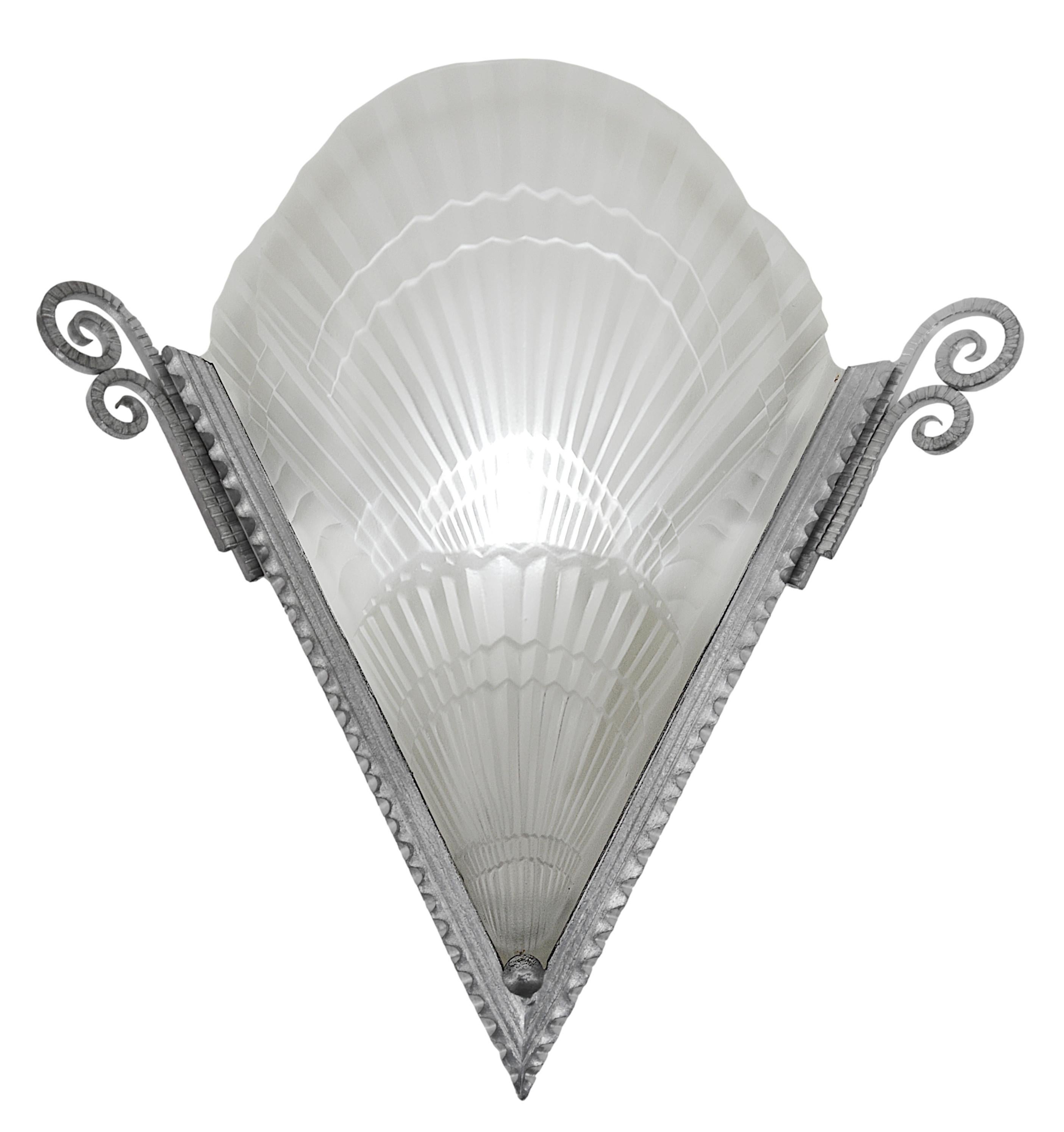 Large French Art Deco pair of wall sconces by Noverdy (Dijon), France, ca.1925. Thick molded glass shades and their wrought-iron fixtures. Scallop shell decor. Each - Height : 12.6