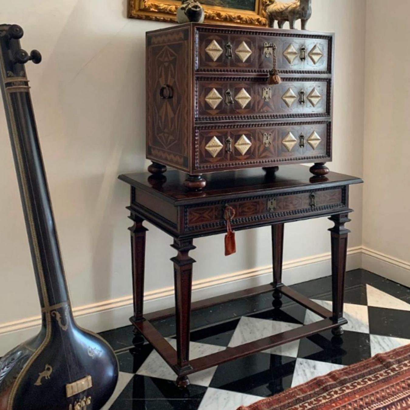 This console was inspired by the Novo Hispanic style of the XVIIIth Century. It is constructed from rosewood and guacanastle wood, with hand crafted Portuguese moldings and geometric marquetry. The legs are squared columns that grow thinner towards