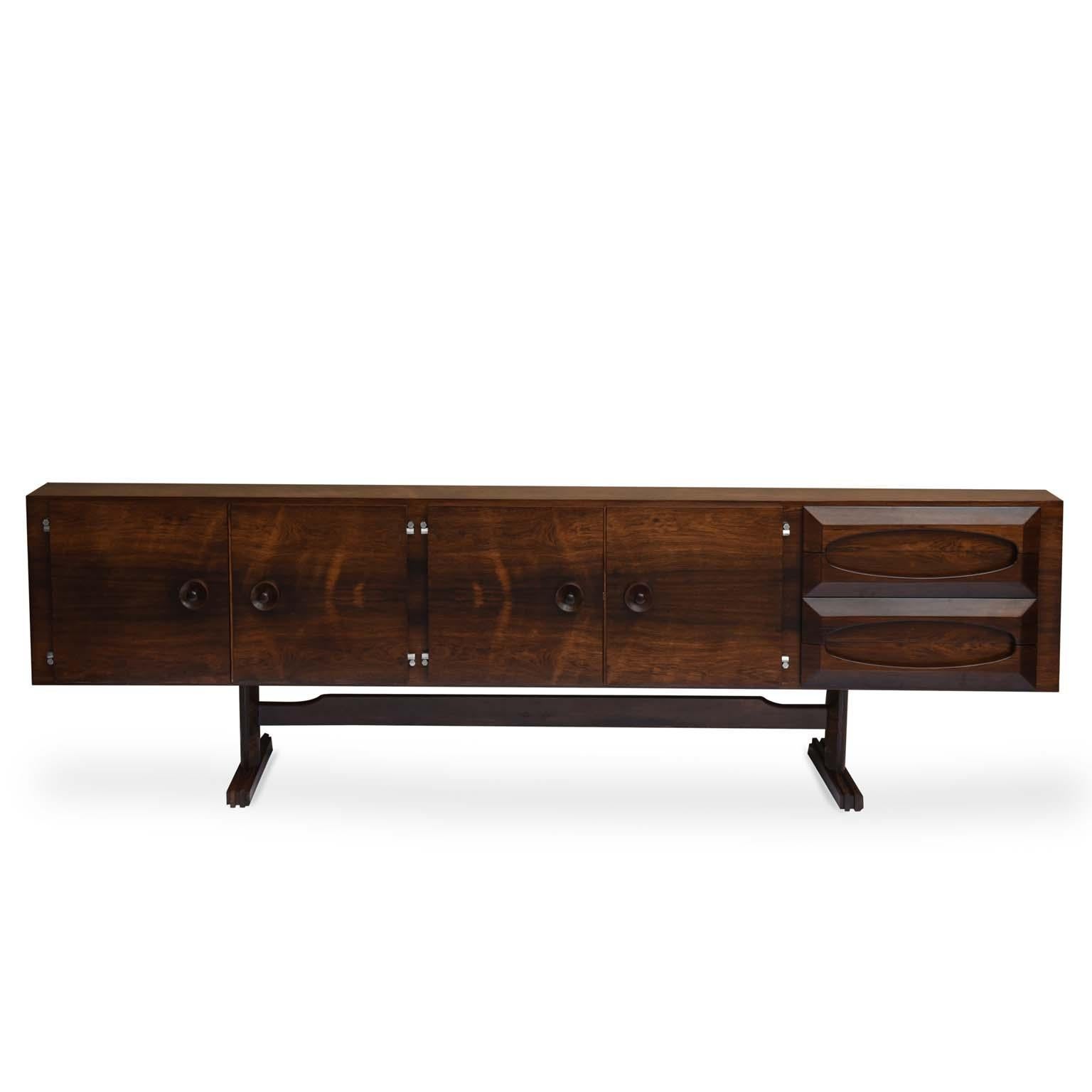 Novo Rumo midcentury Brazilian buffet with rosewood structure, 1960s

Beautiful rosewood buffet with four doors and four drawers.
There are 6 compartments behind the doors with ample storage. The detail of the drawer knobs is the highlight of the